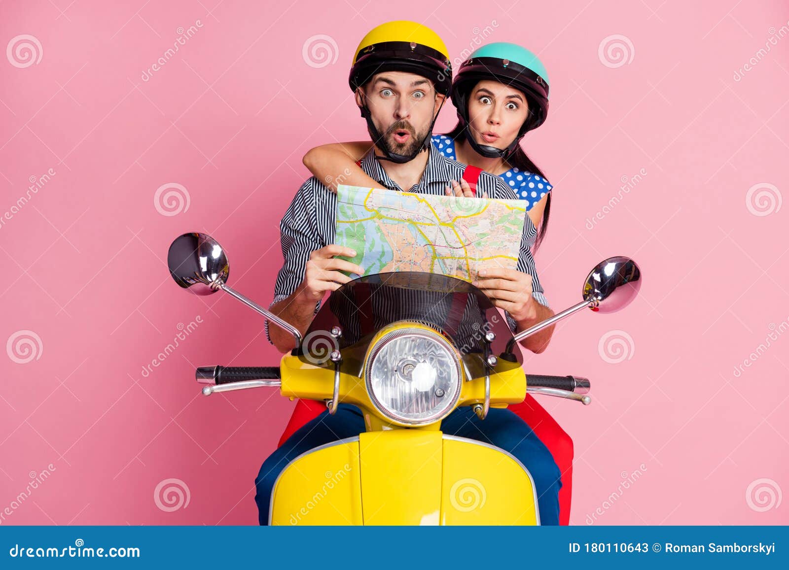 portrait of his he her she nice attractive funny amazed couple driving moped searching address on paper map way rout