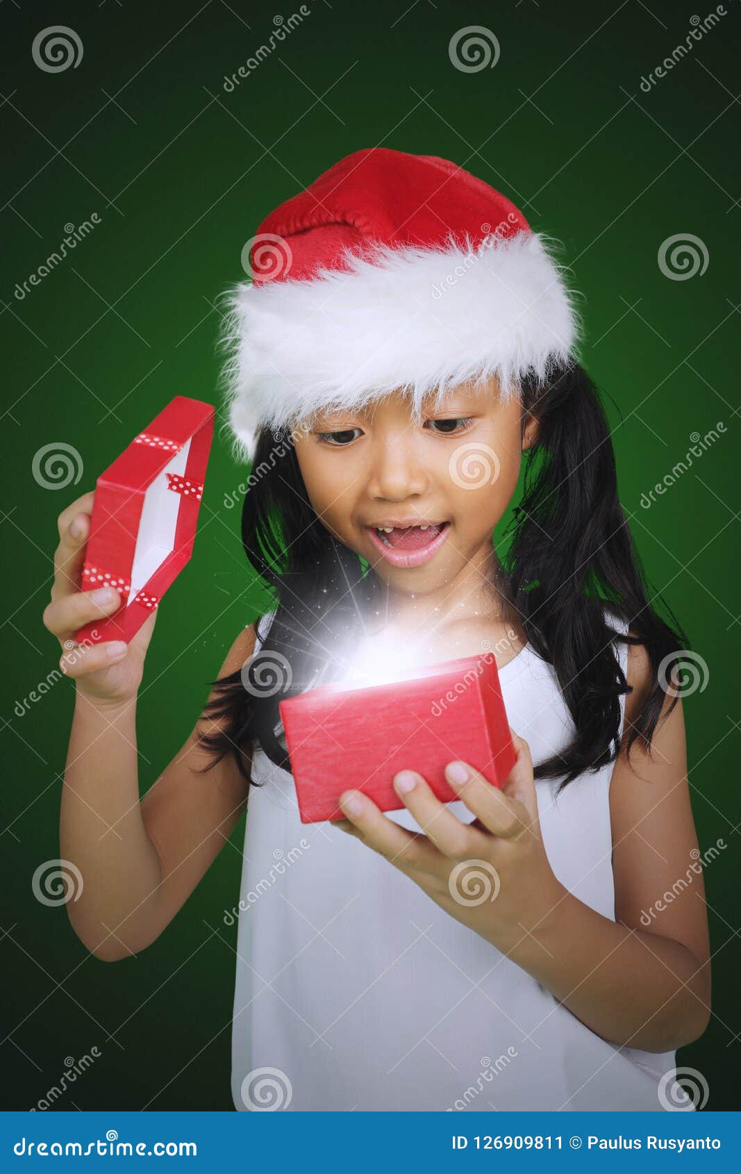 impressed girl opens a christmas gift