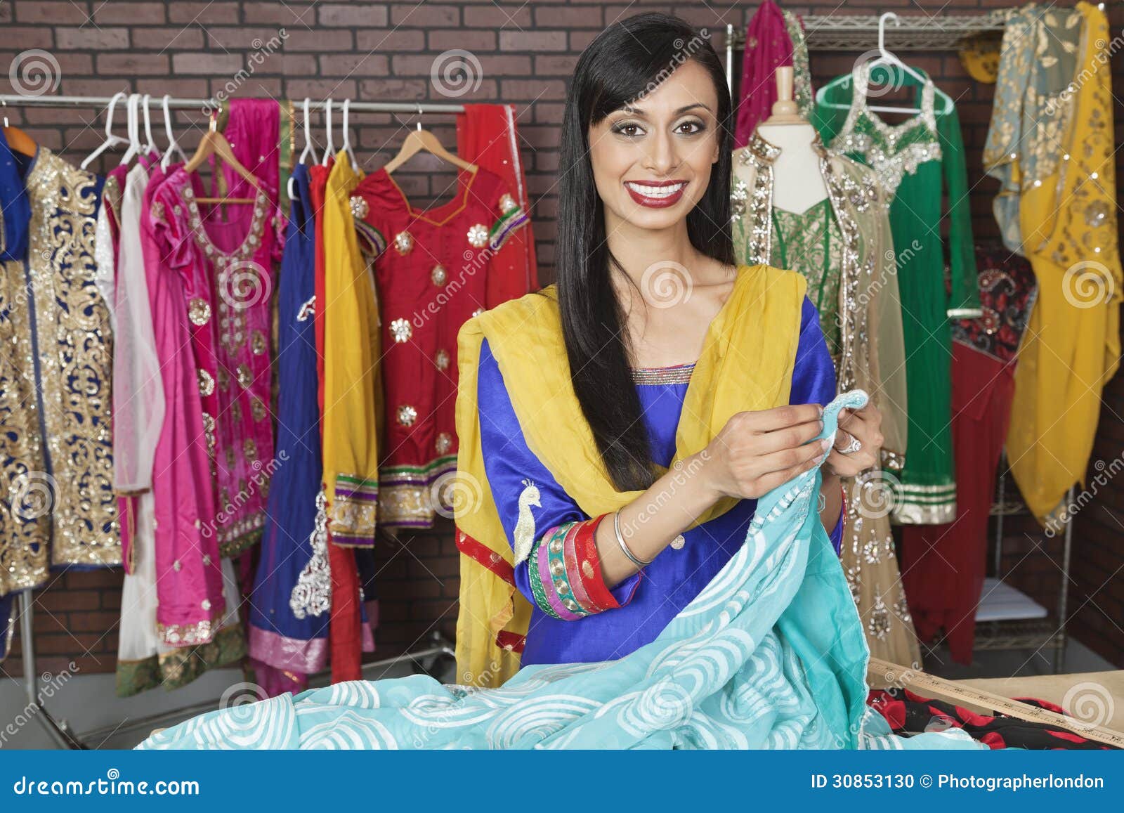 Portrait of an Indian Female Dressmaker Working at Design Studio Stock