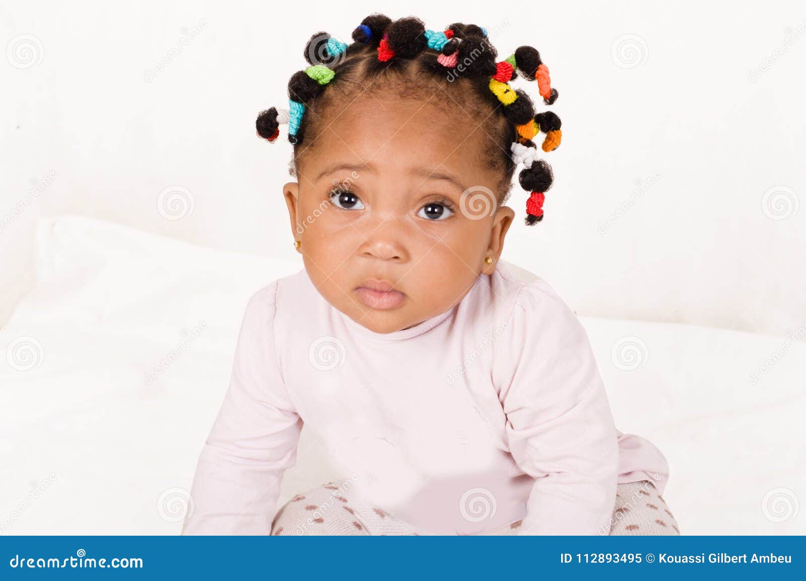 portrait of an infant girl looking at the camera.