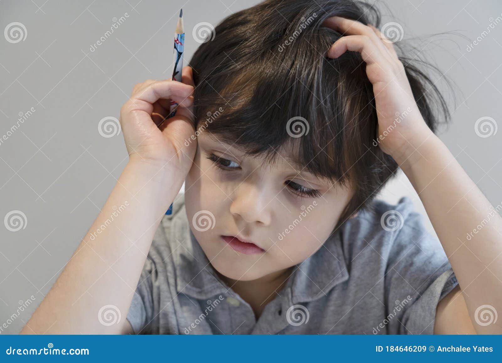 Portrait Kid Boy Holding Black Pen Sitting Alone and Looking Down with  Bored Face ,Lonely Child Looking D Down at Table with Sad Stock Image -  Image of expression, hand: 184646209