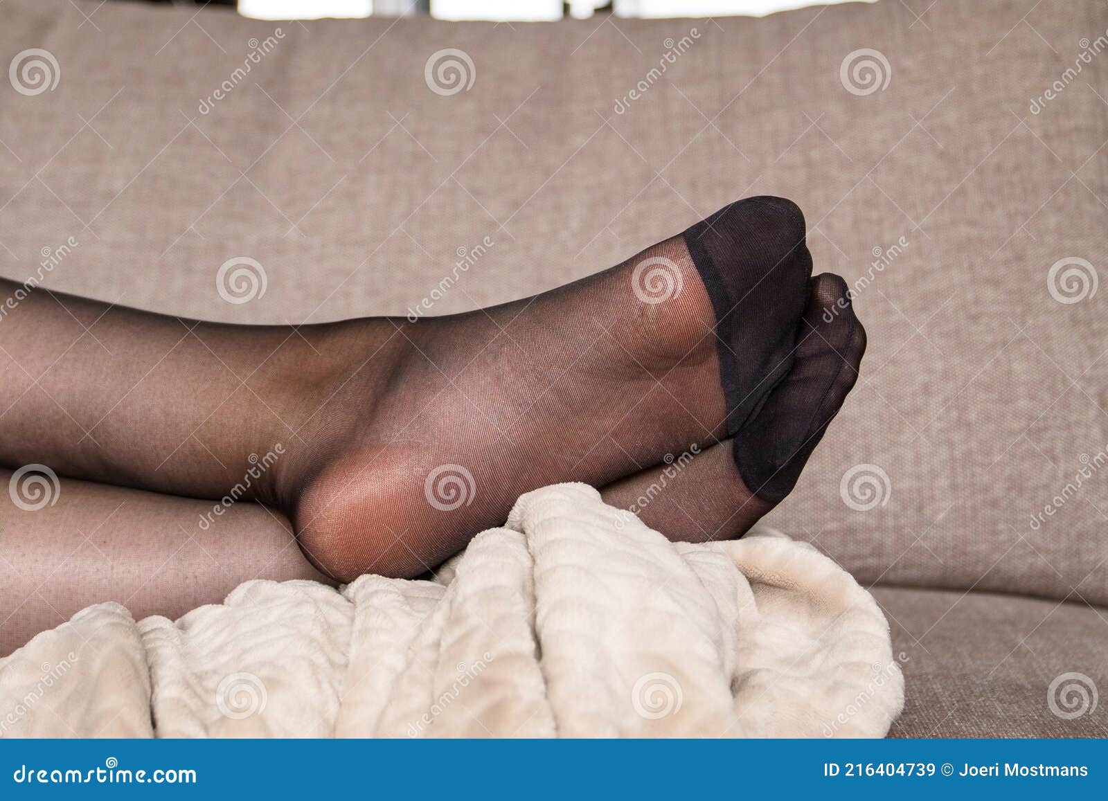 A Portrait of the Legs and Feet of a Woman in Black Nylon Stockings or  Pantyhose Lying on a Couch in a Living Room with Her Legs Stock Image -  Image of
