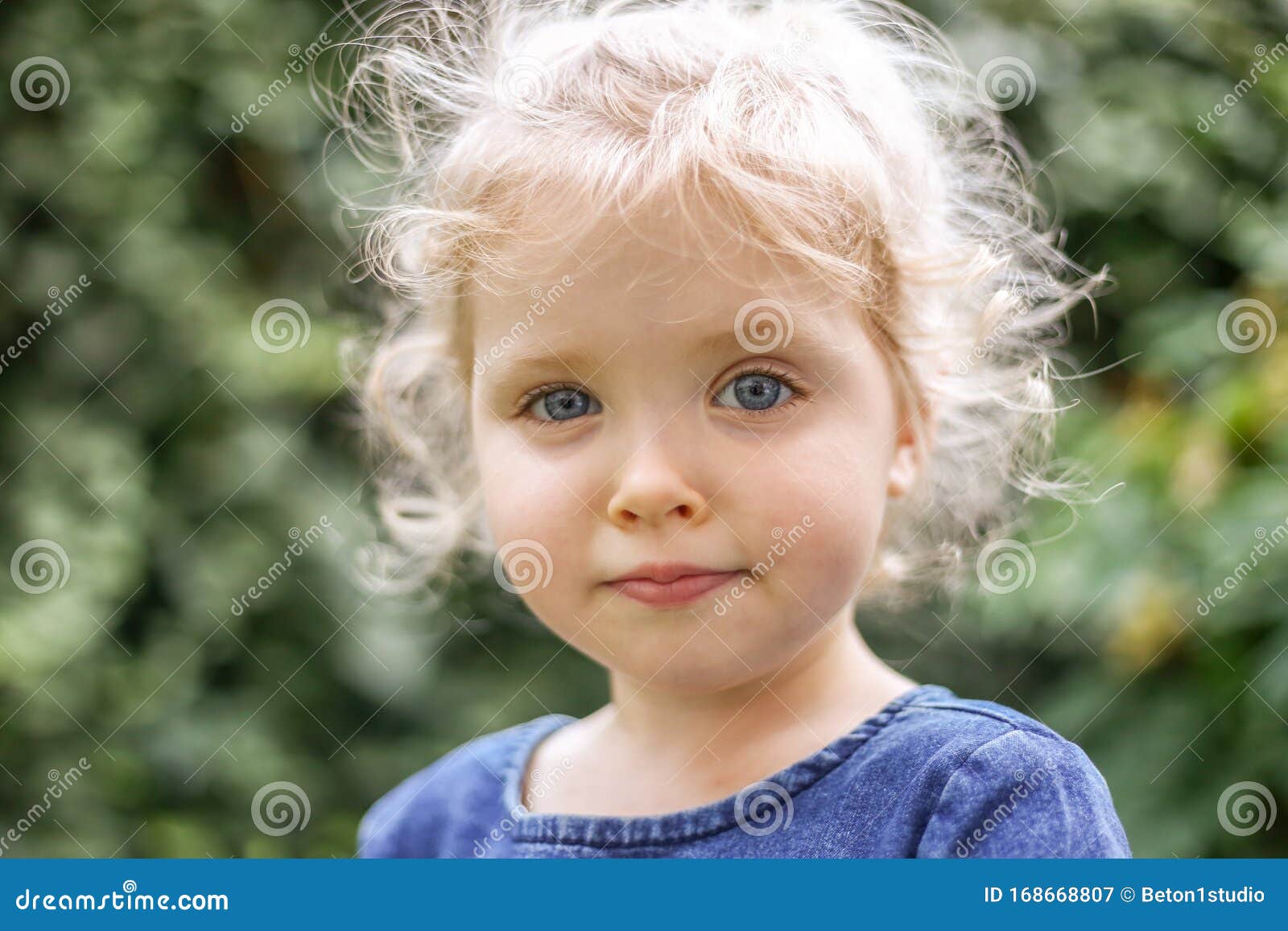 Portrait of a Little Beautiful European Girl with Curly Blonde Hair and Blue  Eyes of 3 To 4 Years in a Classic Blue Color Dress, Stock Image - Image of  cute, child: 168668807