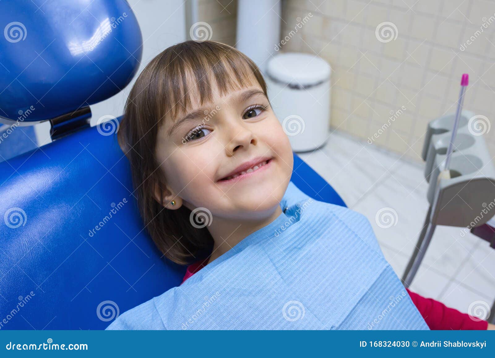 a portrait of a little girl patient in a dental chair in a dentistÃ¢â¬â¢s office