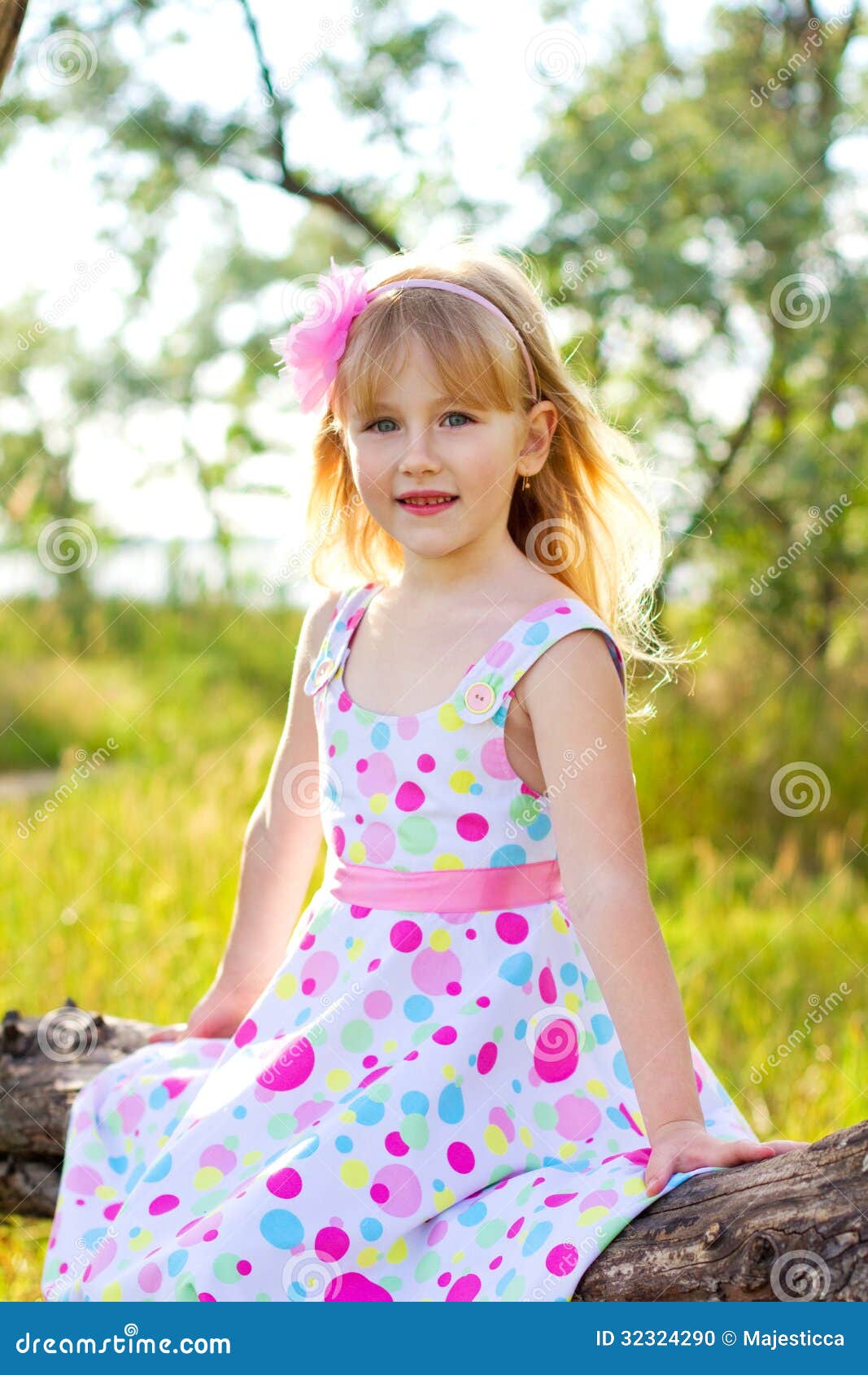 Portrait of Little Girl Sitting on a Tree Branch Stock Photo - Image of ...