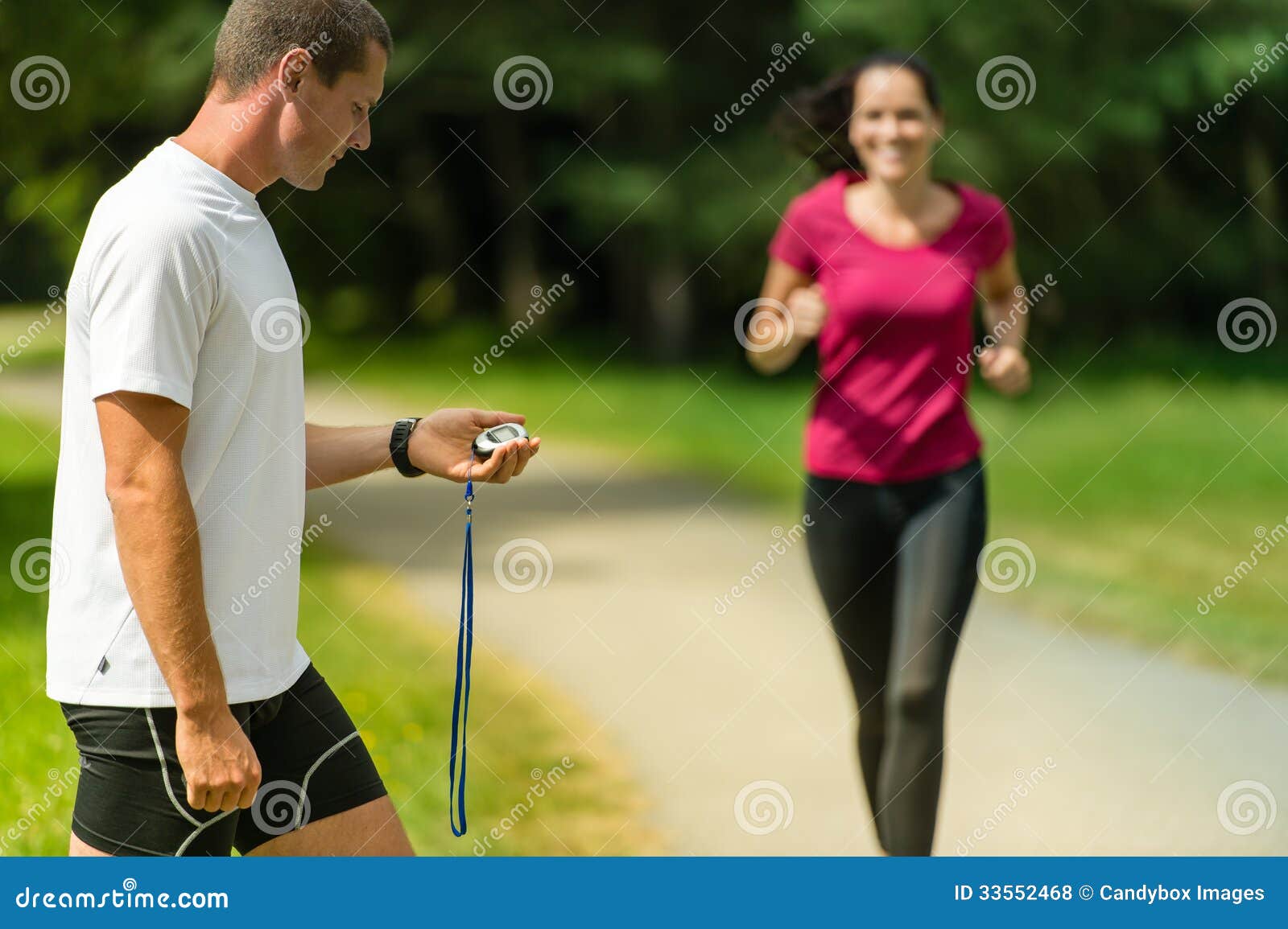 Portrait of Male Coach Timing Runner Outdoors Stock Photo Image of