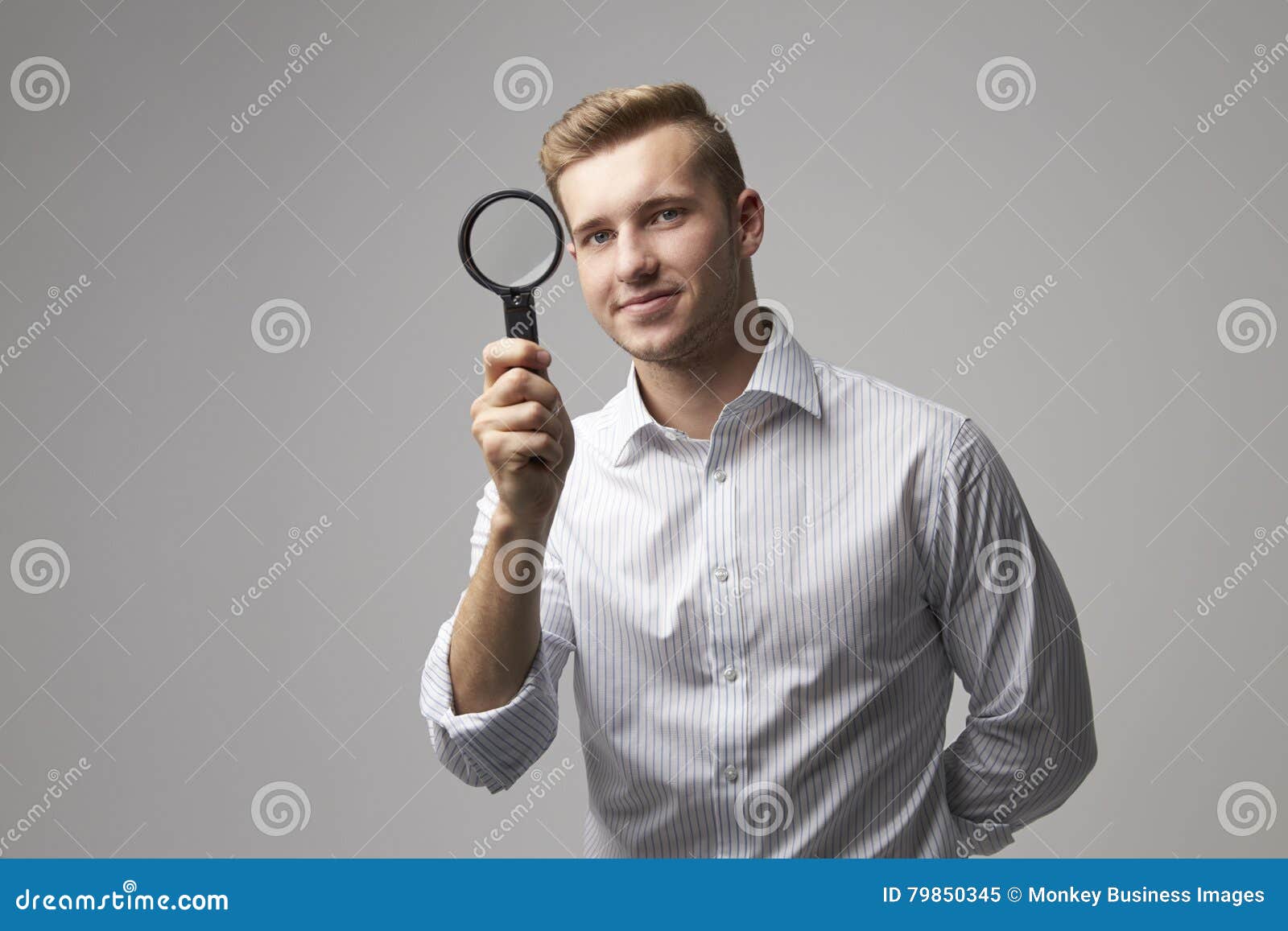 portrait of male criminologist with magnifying glass