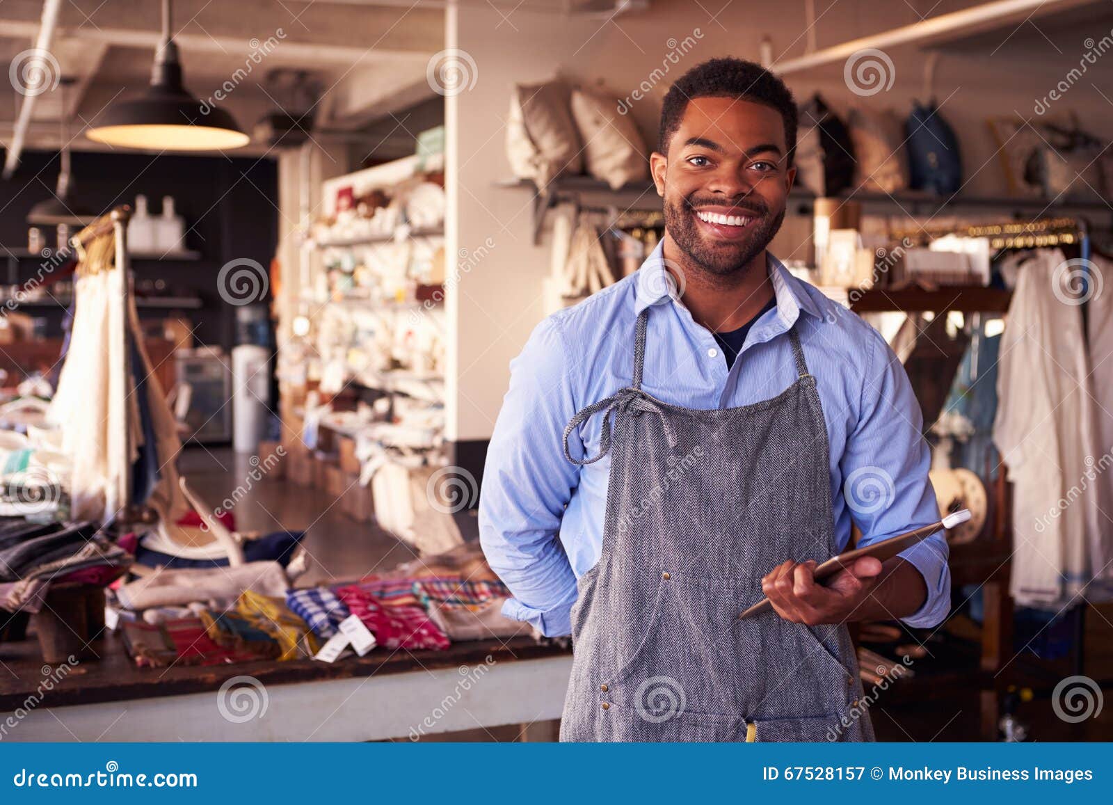 portrait of male owner of gift store with digital tablet