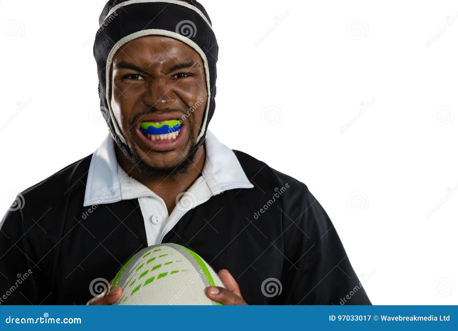 portrait of male rugby player wearing mouthguard white holding rugby ball