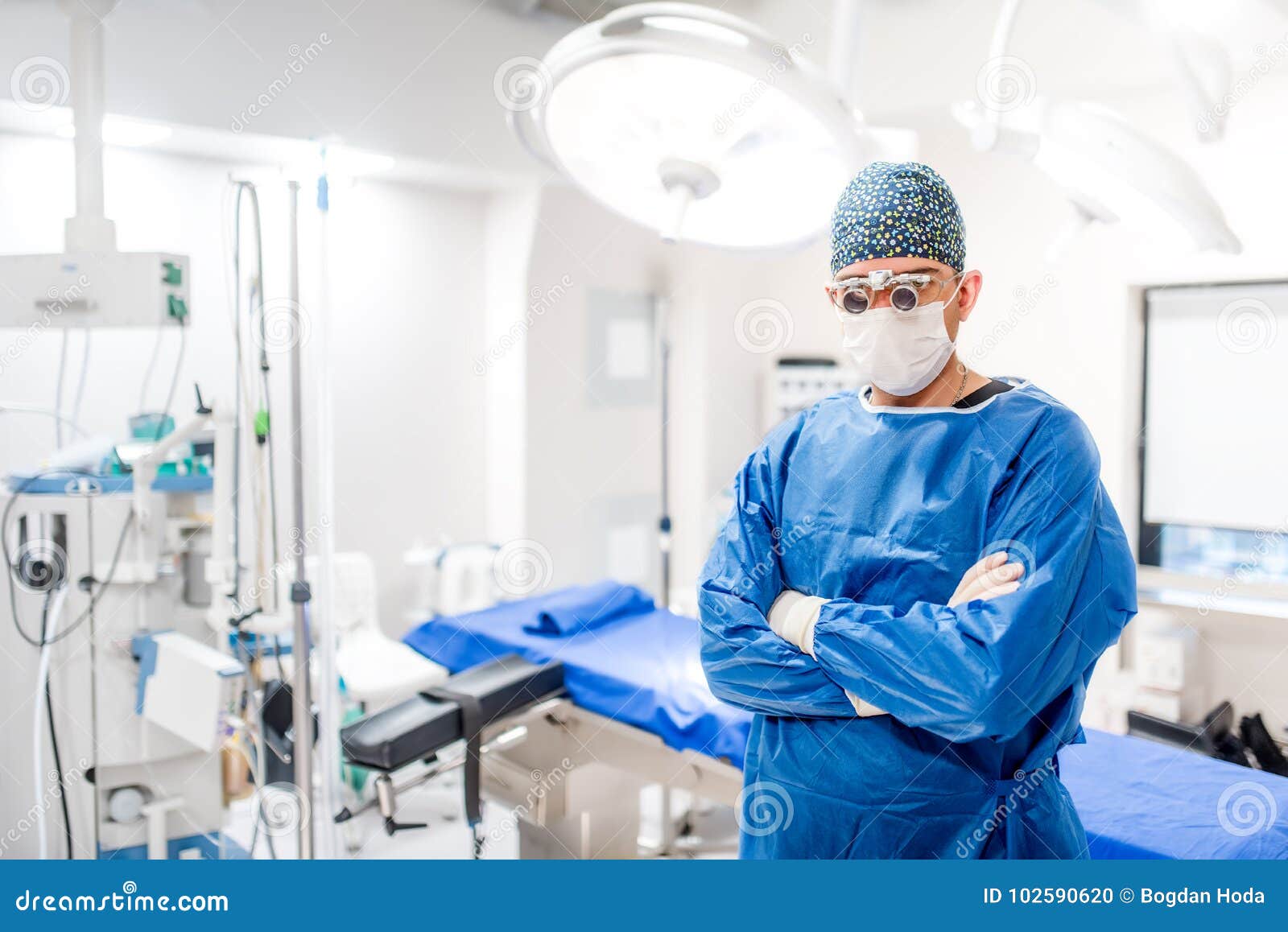 portrait of male surgeon in operating room with surgery lights on and medical devices. modern hospital details