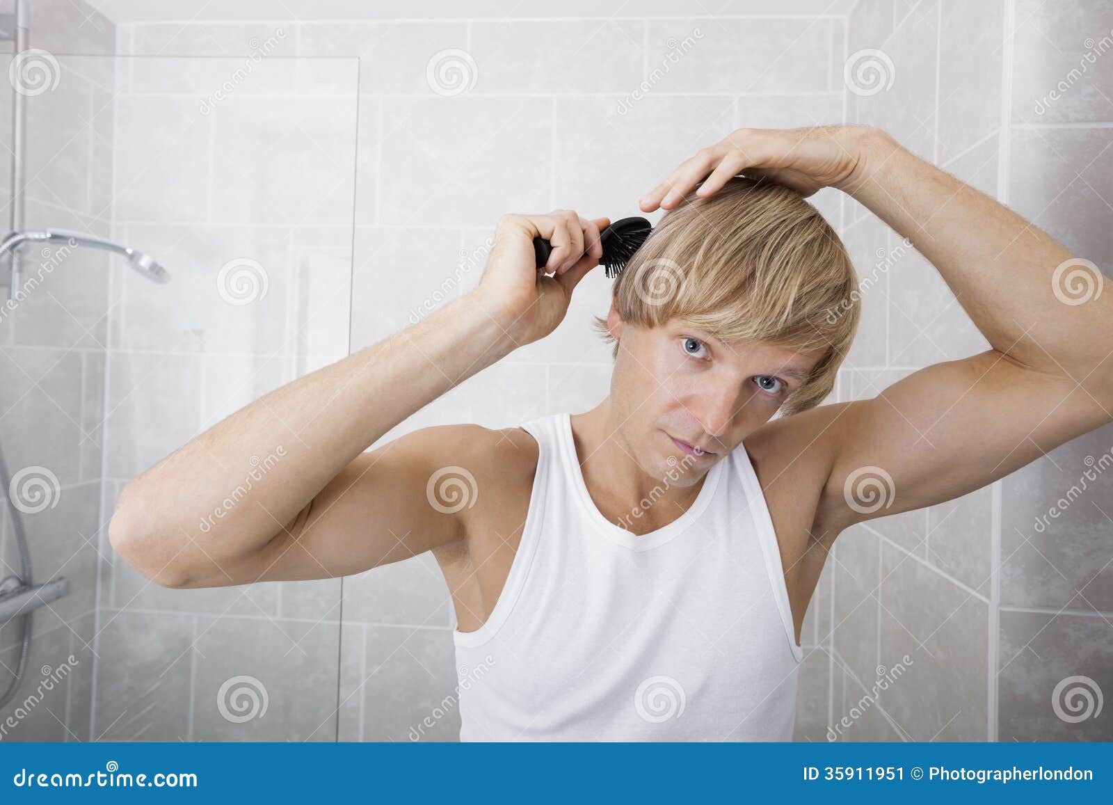 Portrait of Man Combing Hair in Bathroom Stock Image Image of
