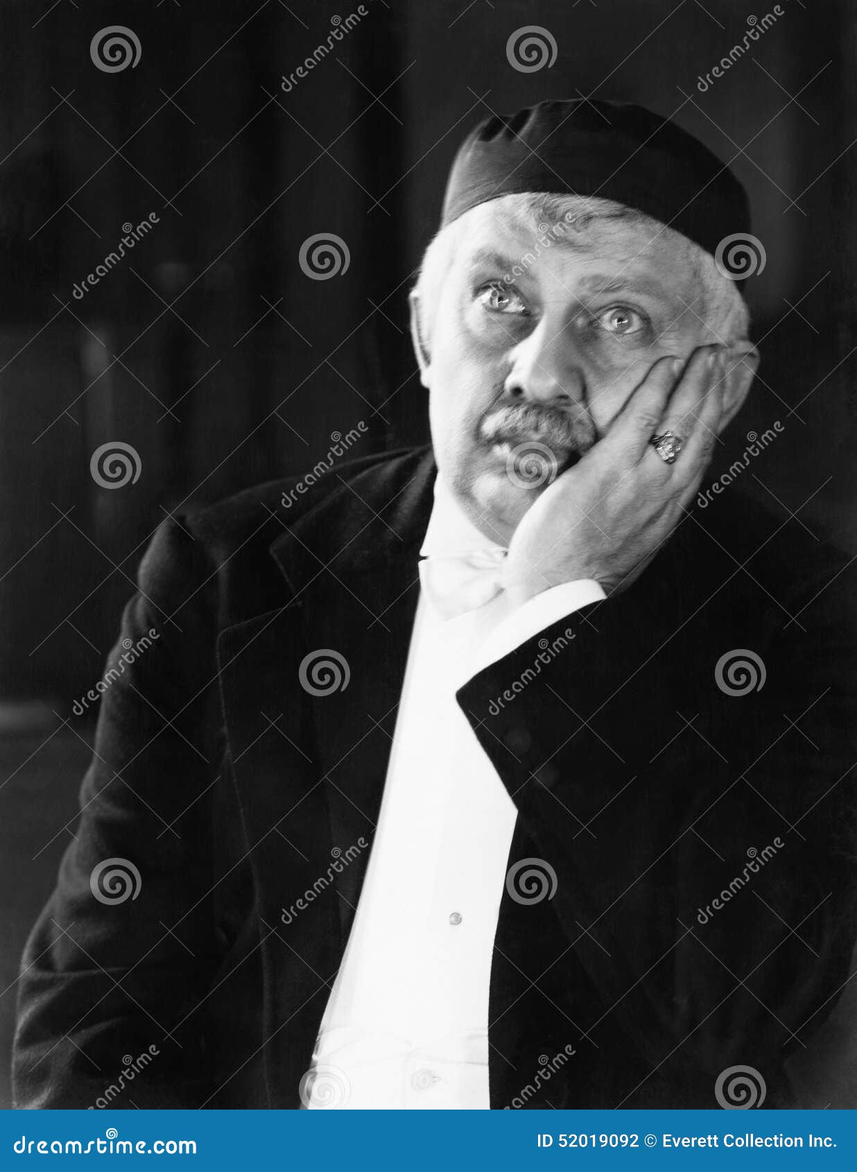 Portrait of a Man Holding His Head in His Hand and Thinking Stock Photo