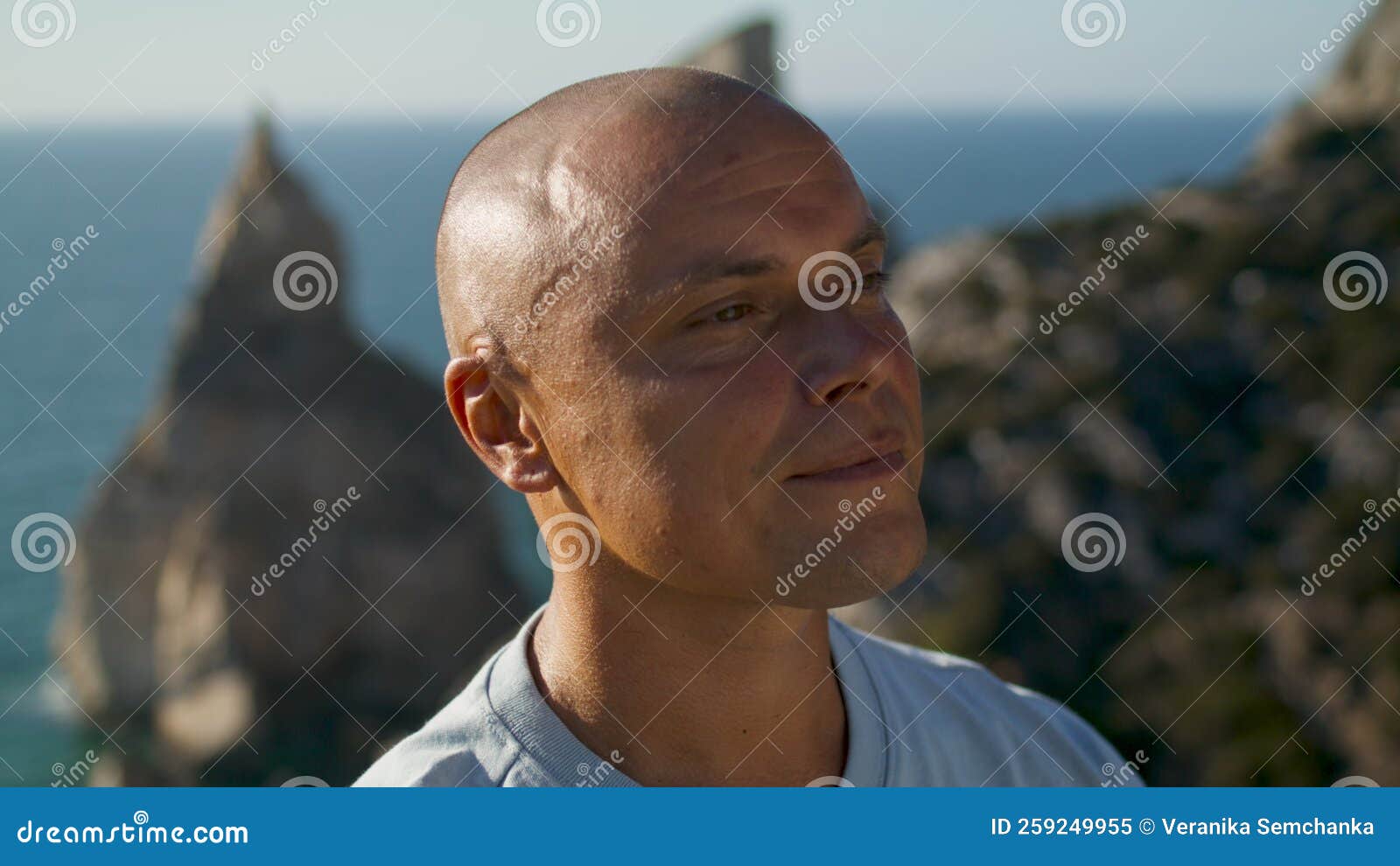 portrait man relaxing ocean view in summer sunlight. happy tourist resting look
