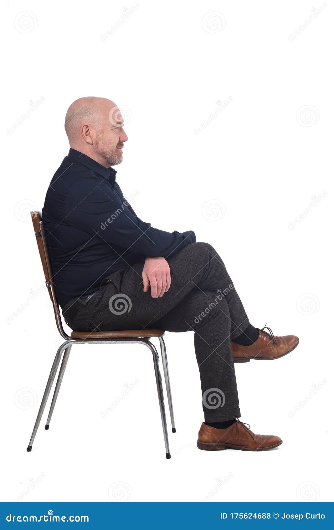 Portrait Of A Man Sitting On A Chair In White Background