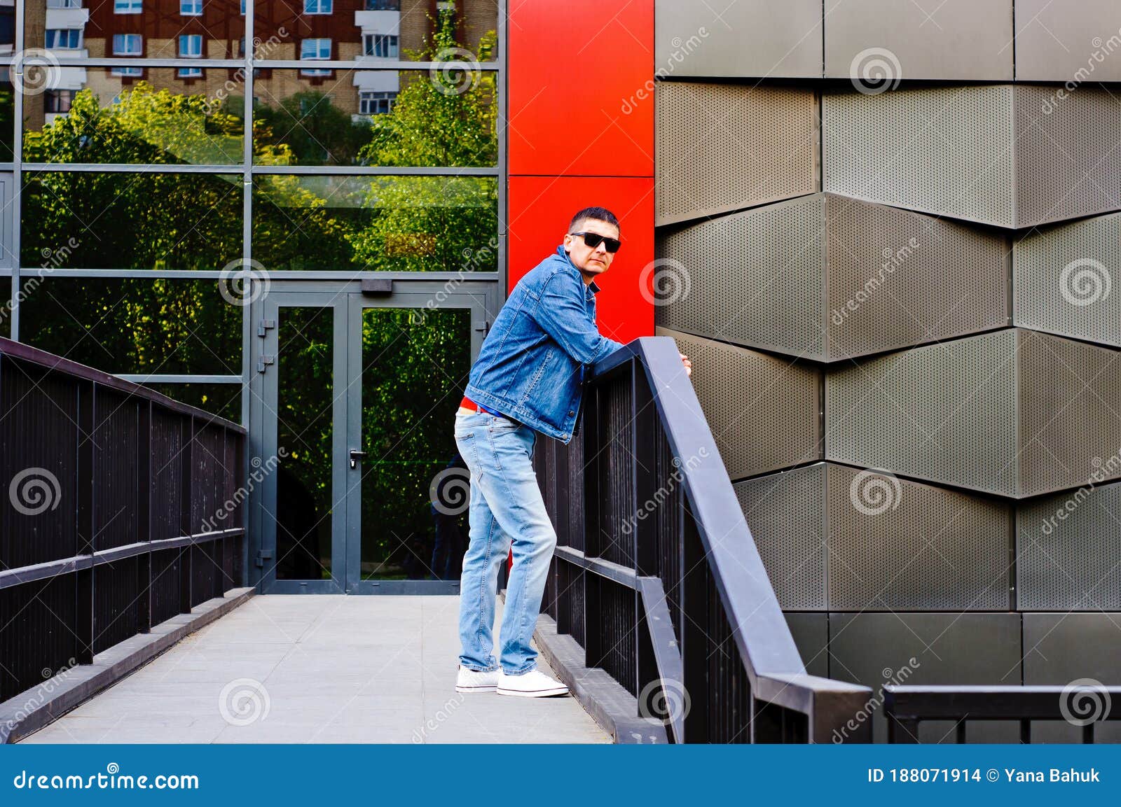 portrait of a man in a sports suit, a jean jacket, a decorative t-shirt and jeans, a walk around the park and a commercial center