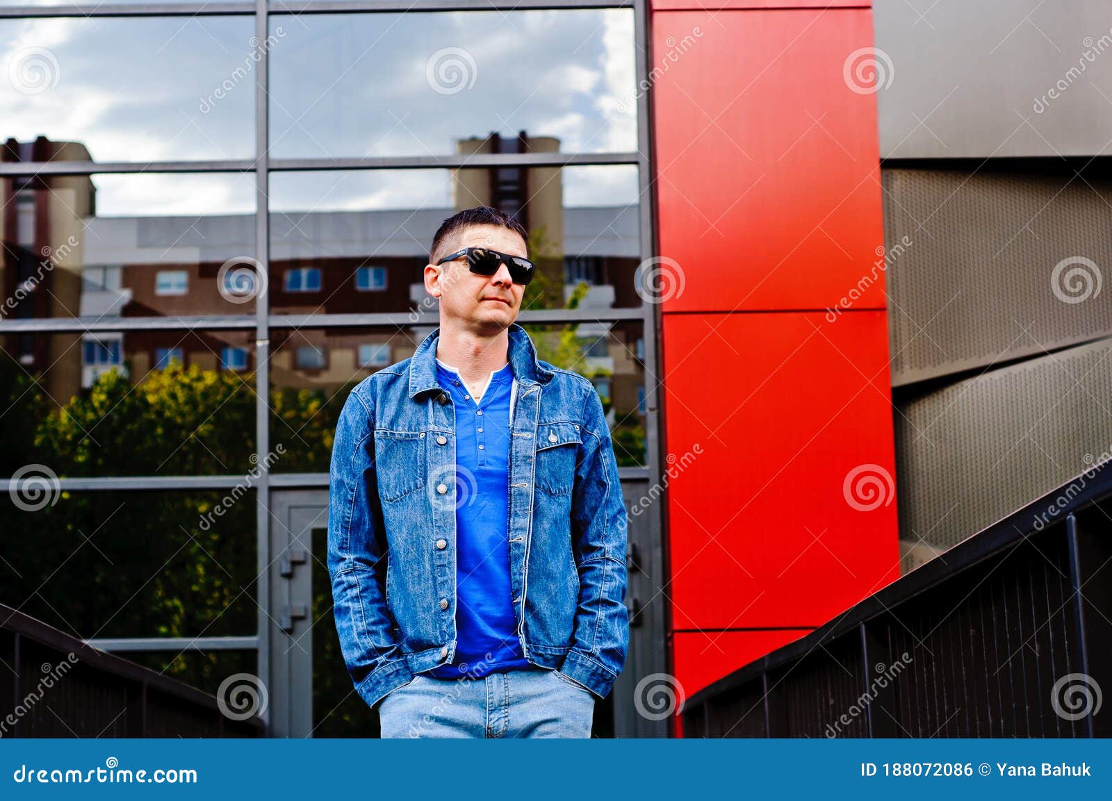 portrait of a man in a sports suit, a jean jacket, a decorative t-shirt and jeans, a walk around the park and a commercial center