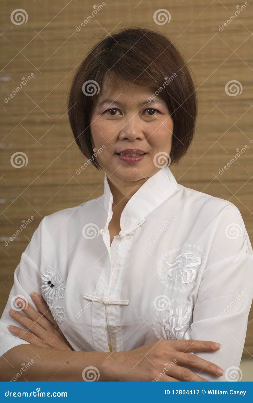 Mature Asian Supervisor Woman Cheerfully Talking To Employees Sitting One Against Another Asian