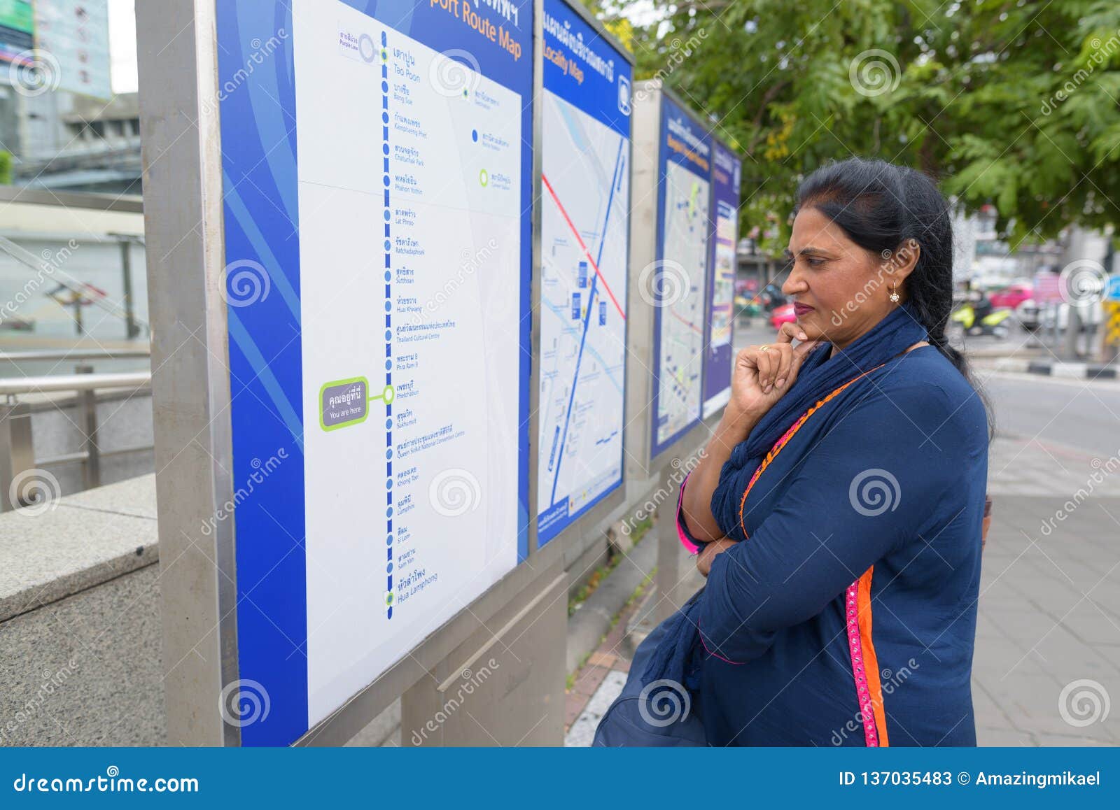 Mature Beautiful Indian Woman Looking At Train Map Outdoors Editorial