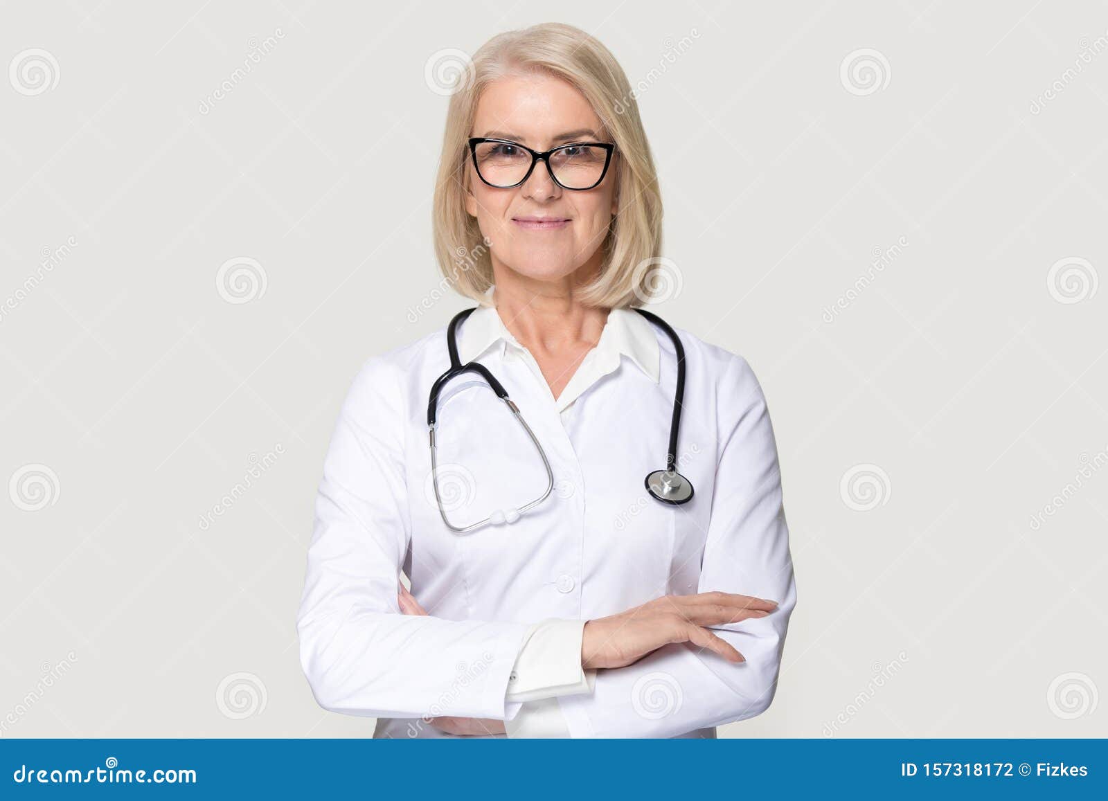portrait of mature female doctor  on grey background