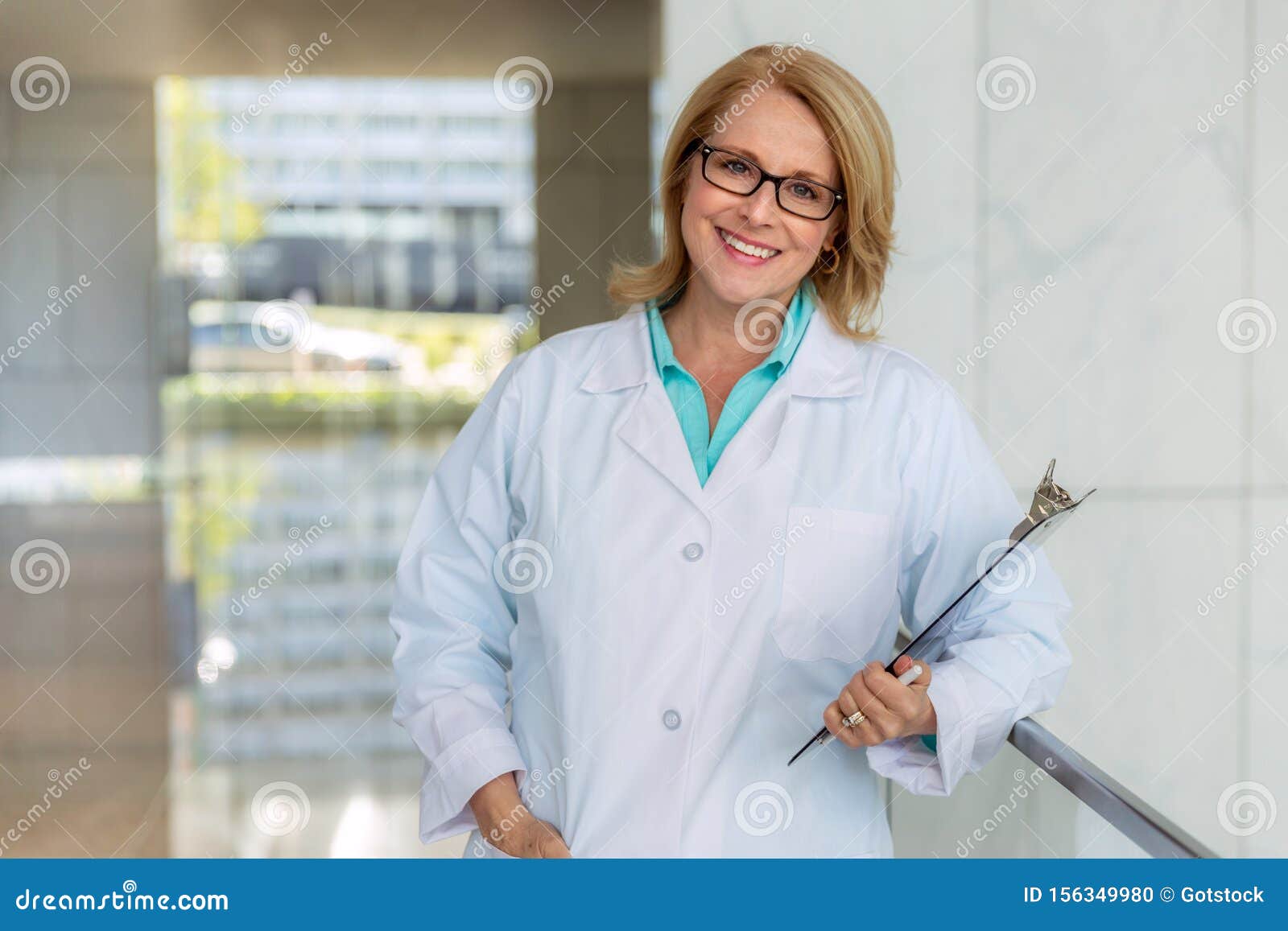 portrait of a mature female medical staff doctor at hospital, genuine warm smile, qualified practitioner, experienced physician