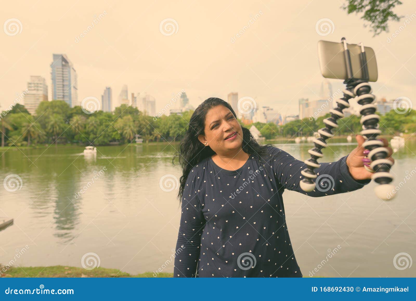 Portrait Of Mature Indian Woman Relaxing At The Park Stock Photo