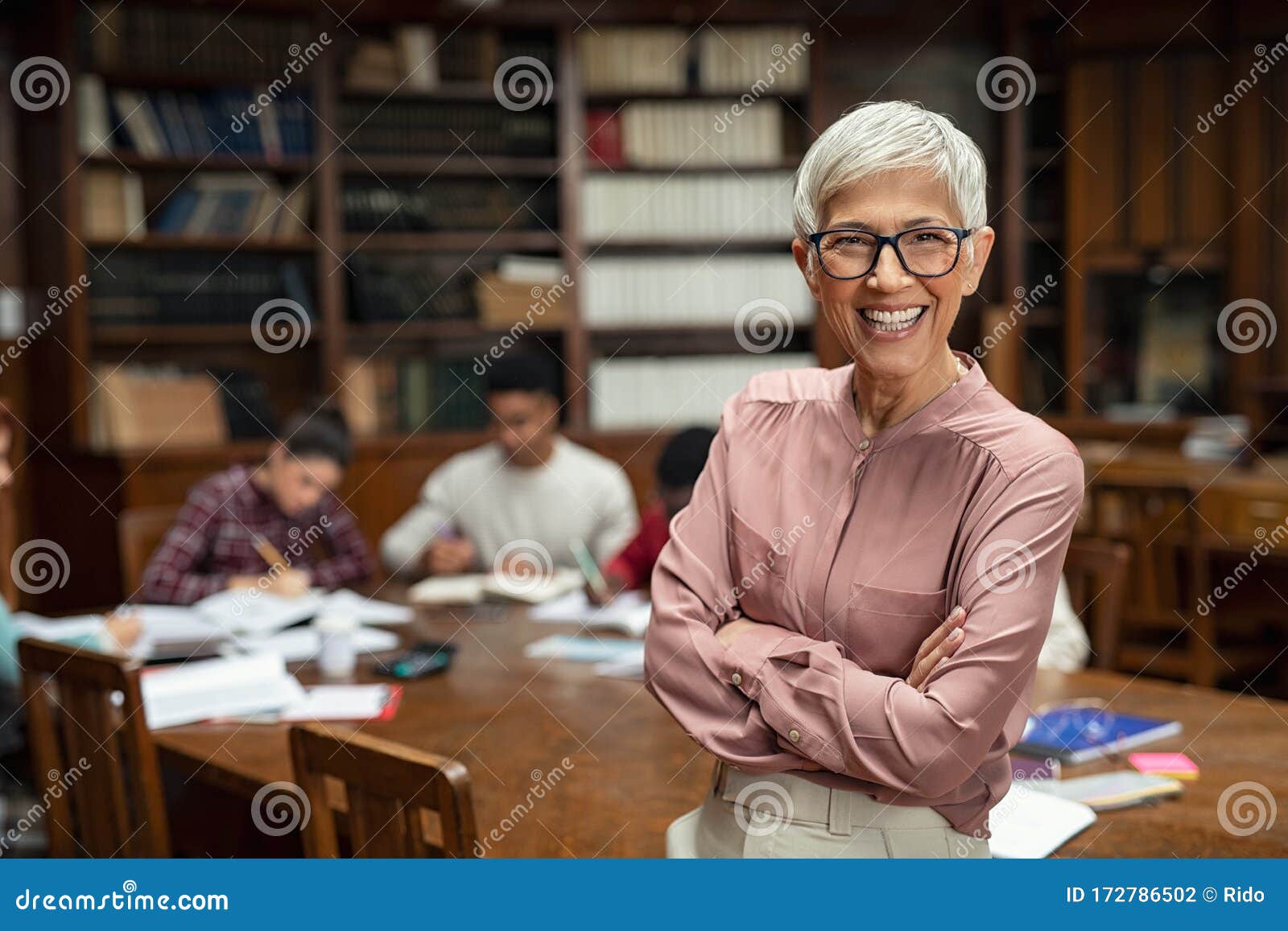 smiling university professor in library