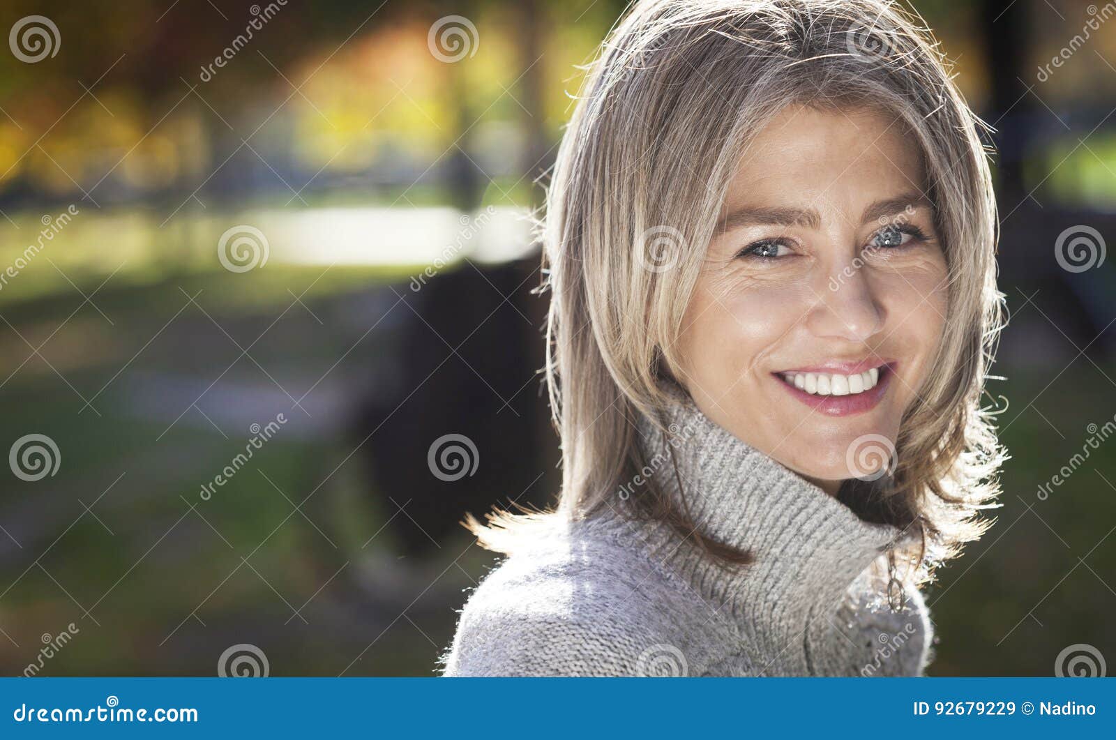 portrait of a mature woman smiling at the camera.gray hairs.