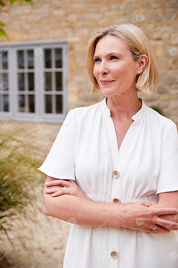 Portrait Of Mature Woman Standing Outside Front Door Of Home Stock Image Image Of Female