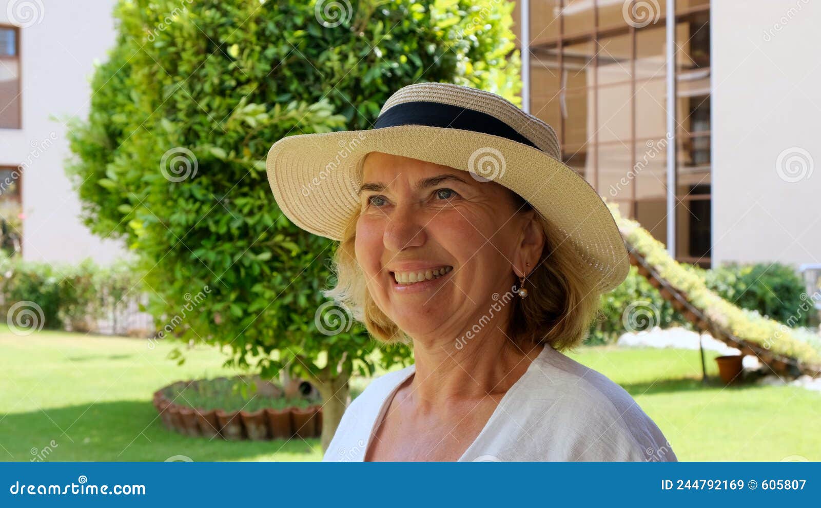 Portrait Of A Mature Woman 55 60 Years Old With A Toothy Smile In A Sun 
