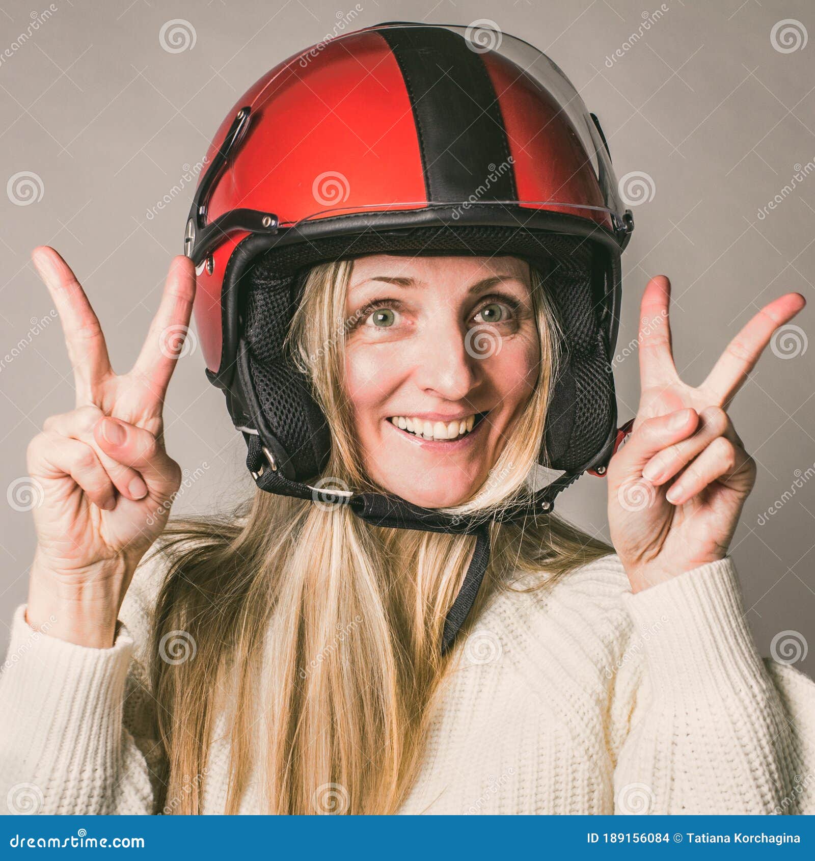 Portrait of Middle Years Beautiful Blonde, Woman Hero, in Motorcycle Helmet  Gesturing Two V-signs, Peace Symbols, on Stock Photo - Image of adult,  drive: 189156084