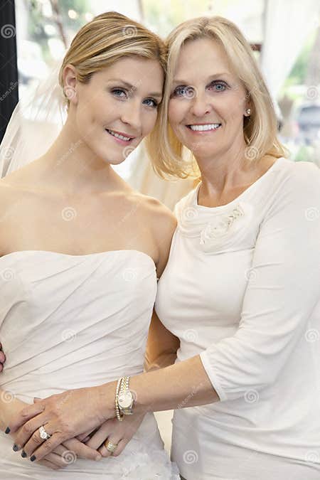 Portrait Of A Mother With Daughter Dressed As Bride In Bridal Store Stock Image Image Of