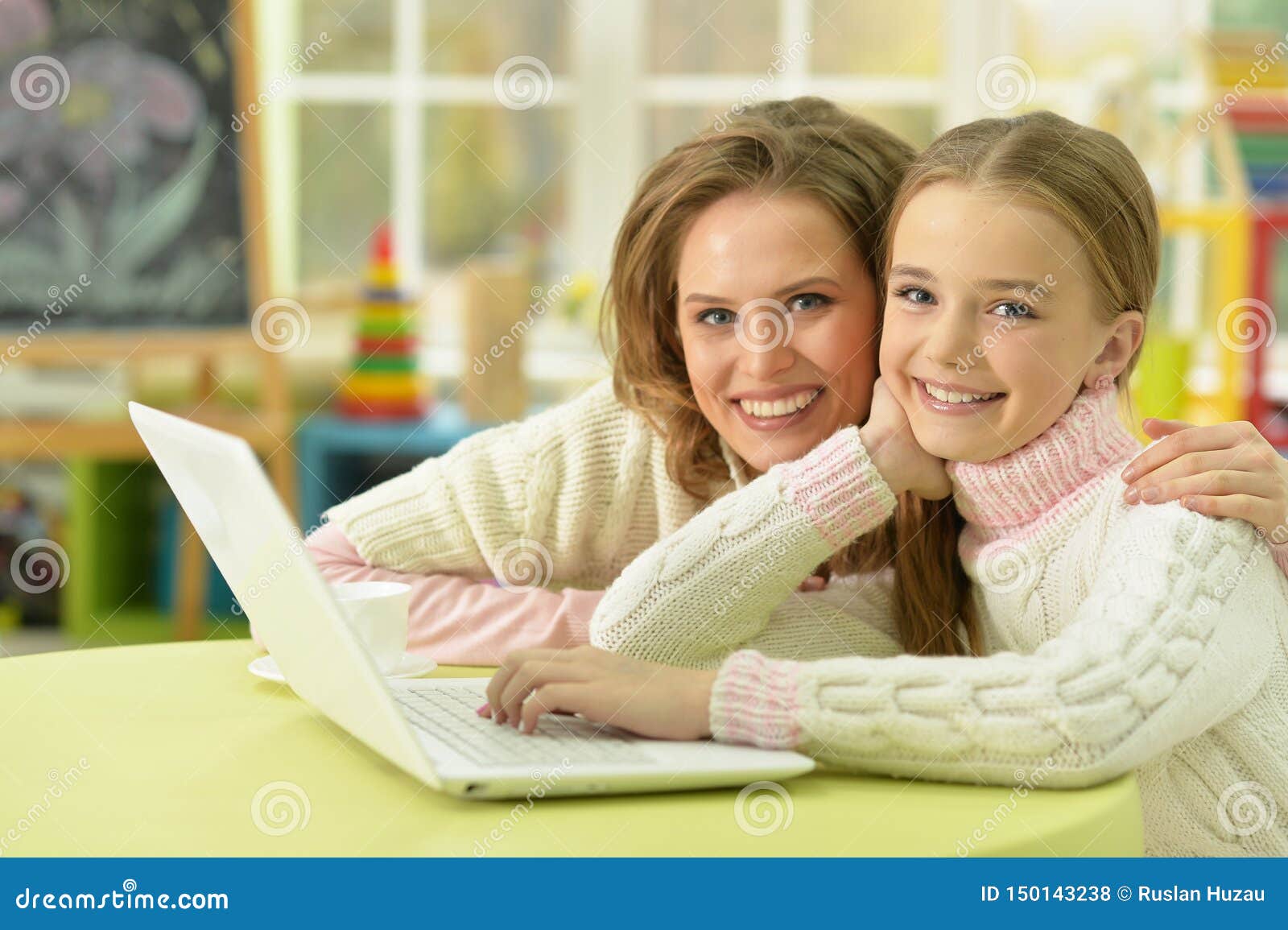 Mother And Daughter Wiping A Table Stock Image - Image of 