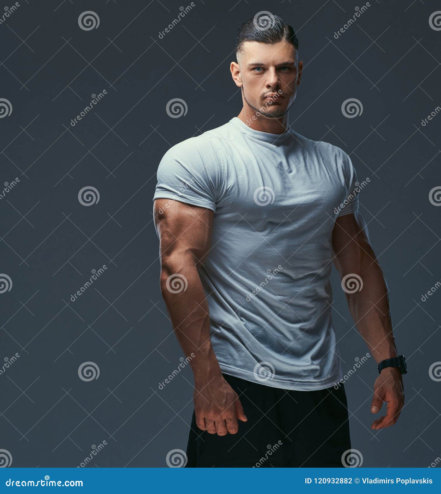 Portrait of a Muscular Handsome Bodybuilder in Sportswear Posing in a ...