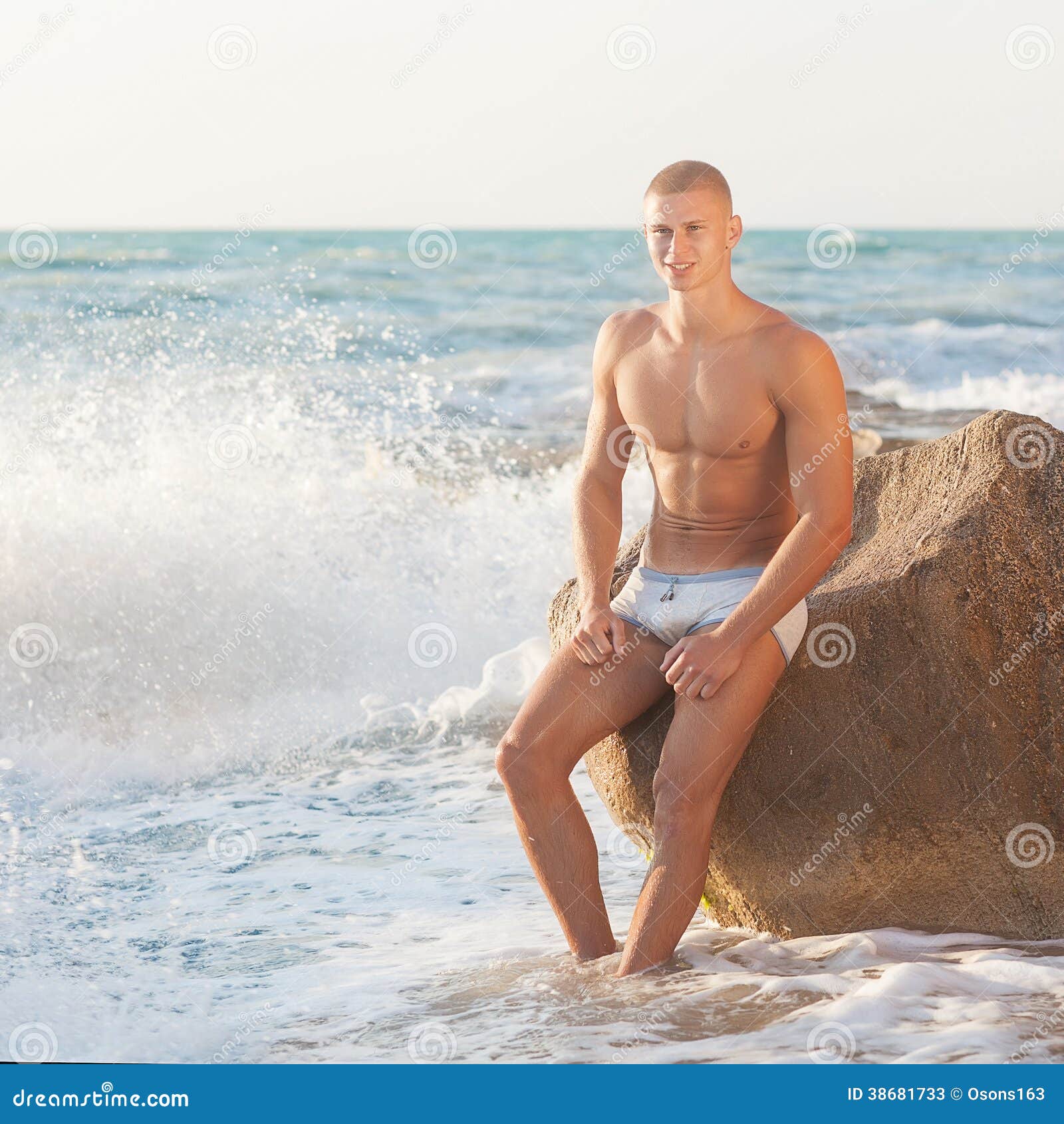 A bulky, muscular guy on the beach