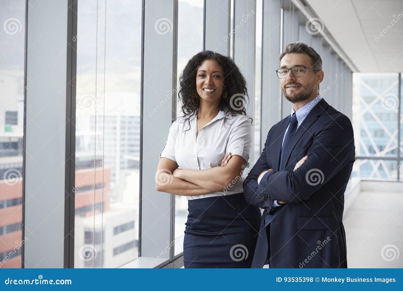 portrait of new business owners in empty office