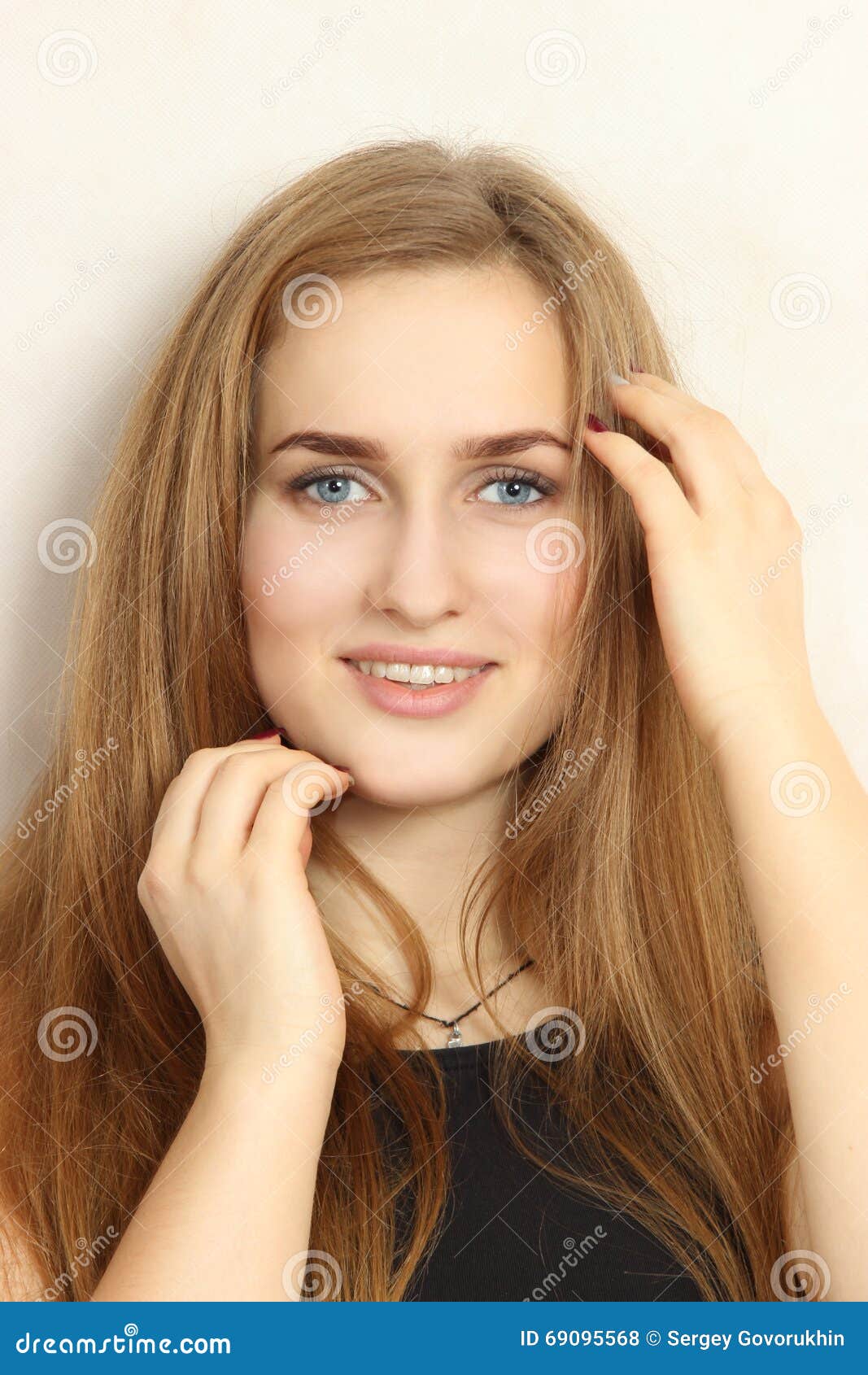 Portrait Of The Nice Young Girl On A White Background Stock Photo