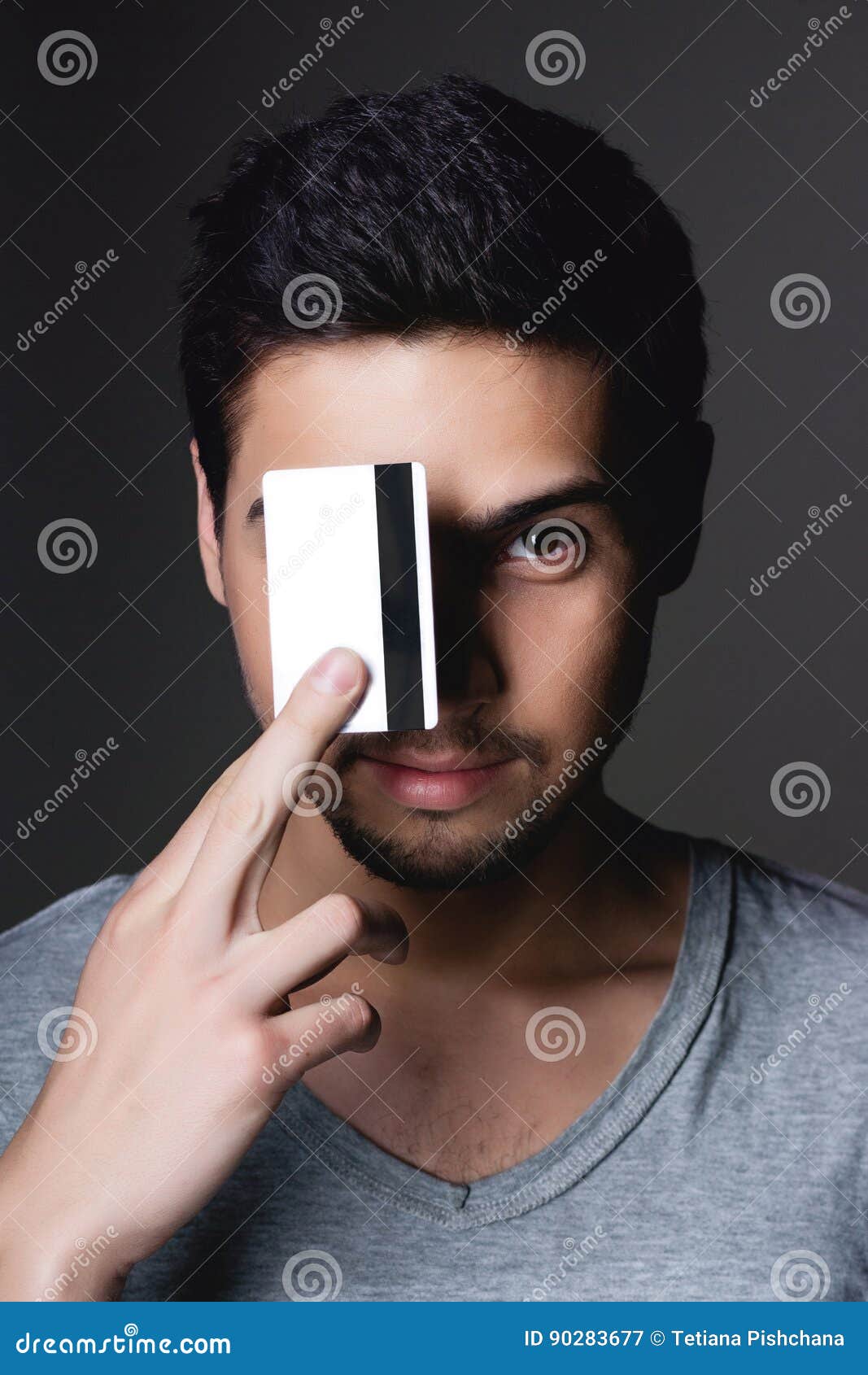 Portrait Of A Normal Boy Smiling Over Grey Background With A Credit