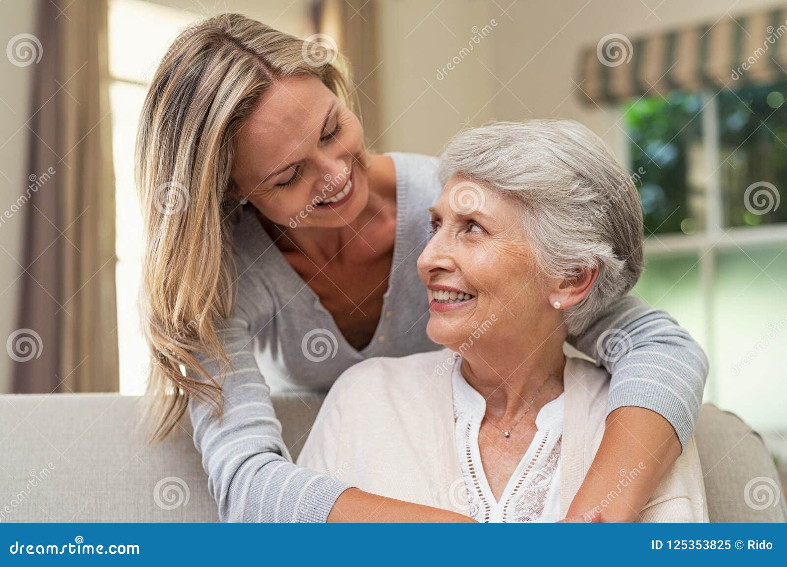 Woman Embracing Senior Mother Stock Image