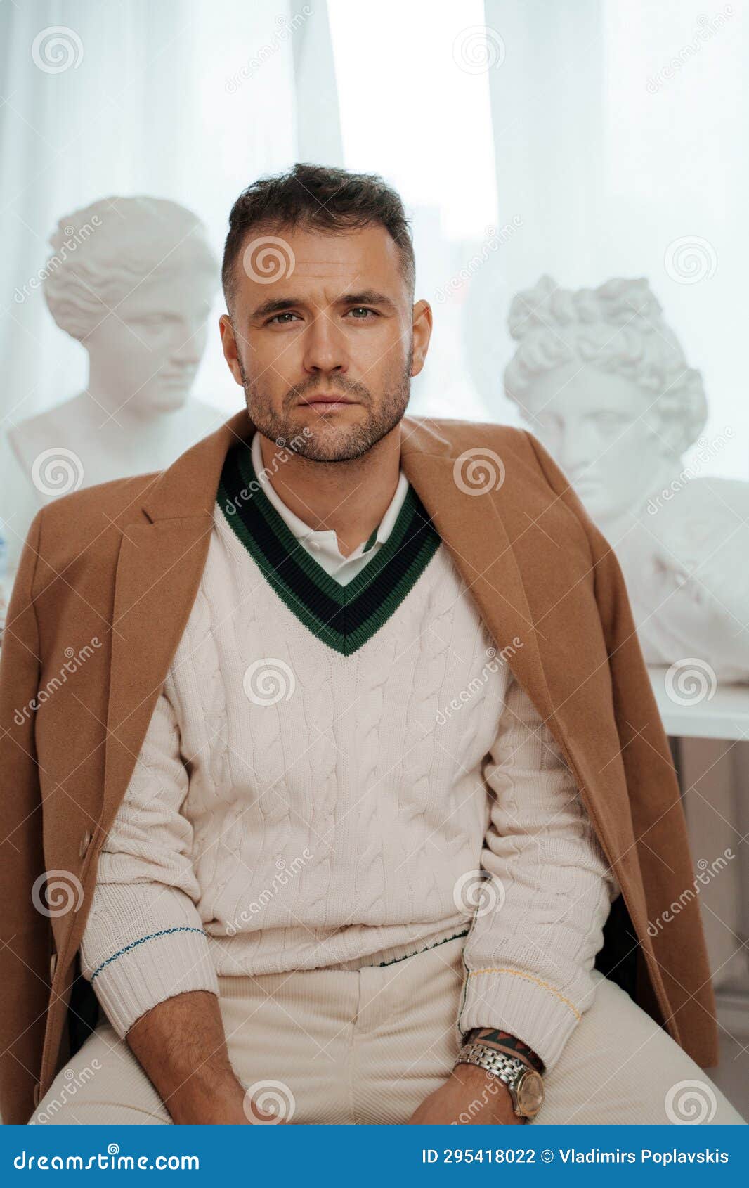 gentleman in old-money style among classical greek sculptures