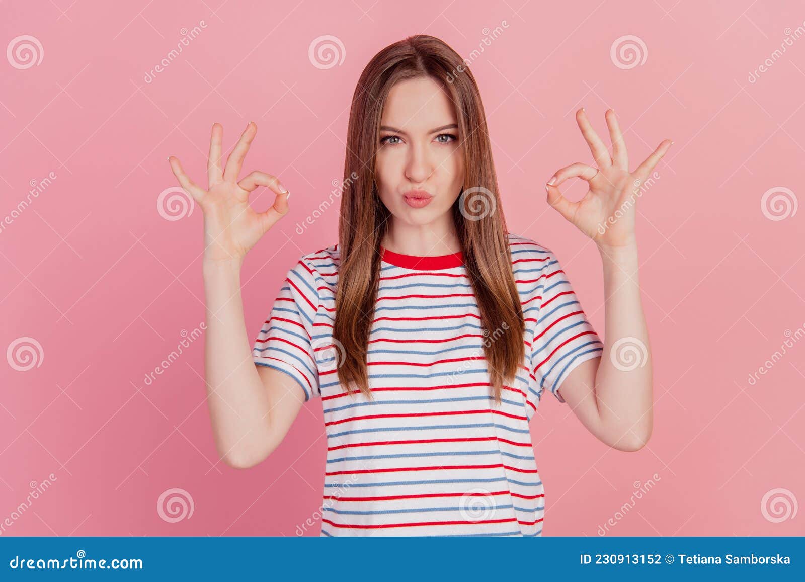 portrait of pertty cute romantic lady fingers show okey gesture send air kiss on pink background