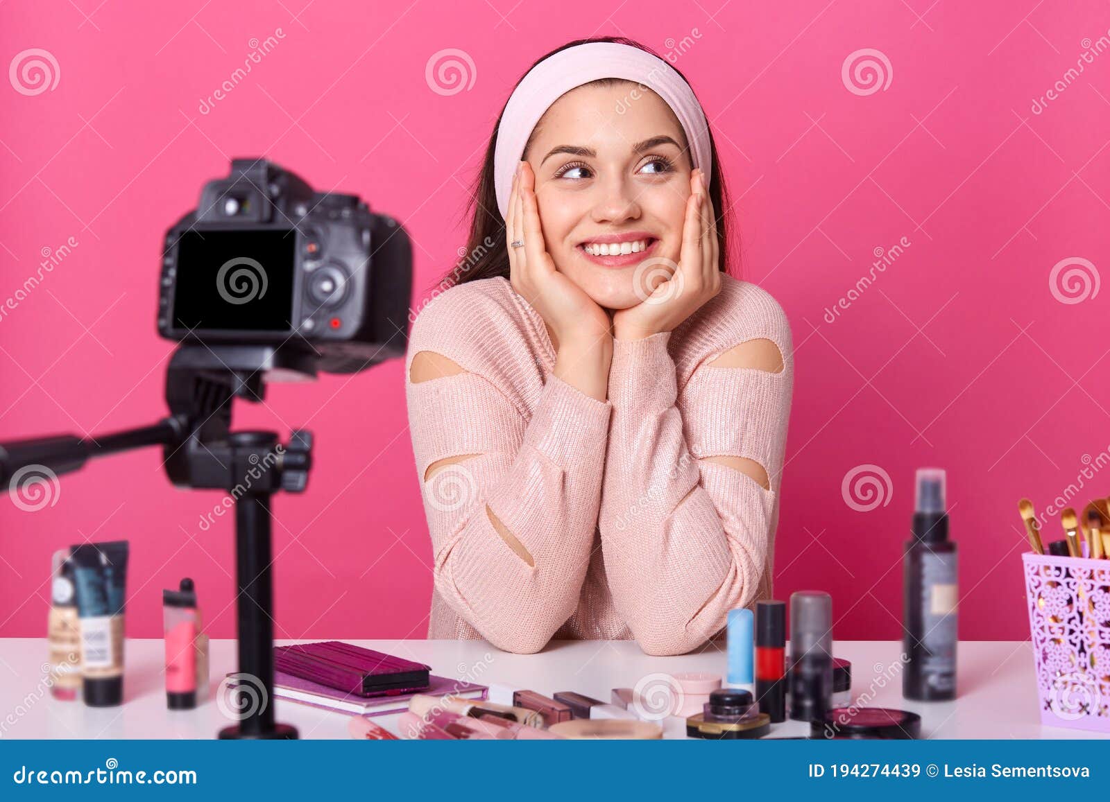 Portrait of Positive Young Female Blogger Filming Video for Her Blog, Lady  with Hair Band Sitting at Dressing Table Against Pink Stock Image - Image  of joyful, female: 194274439