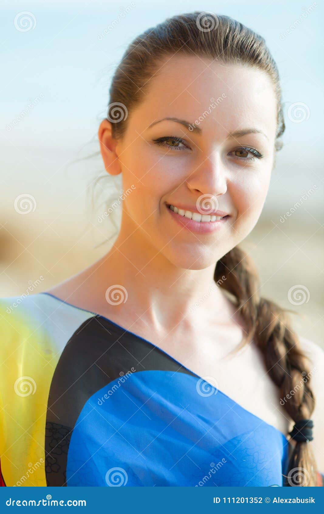 portrait of pretty girl with braid in asymmetrical dress