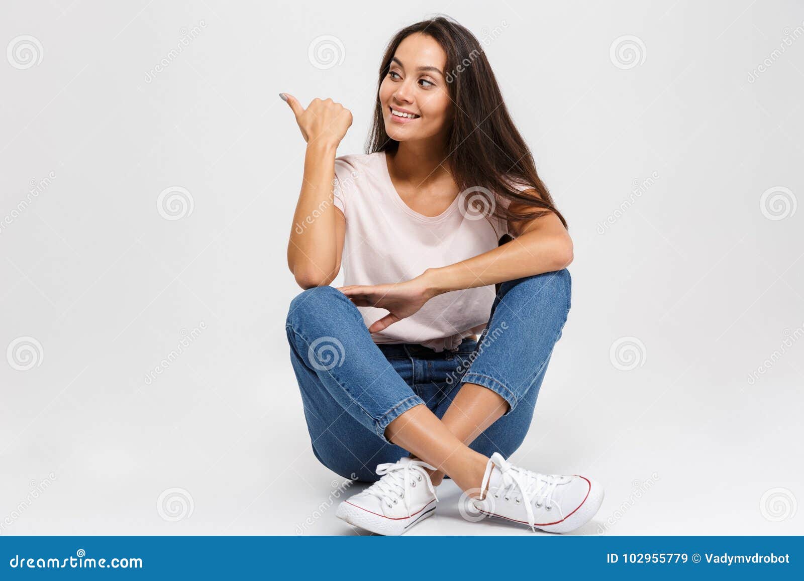 Portrait Of A Pretty Smiling Asian Girl Pointing Finger Away Stock