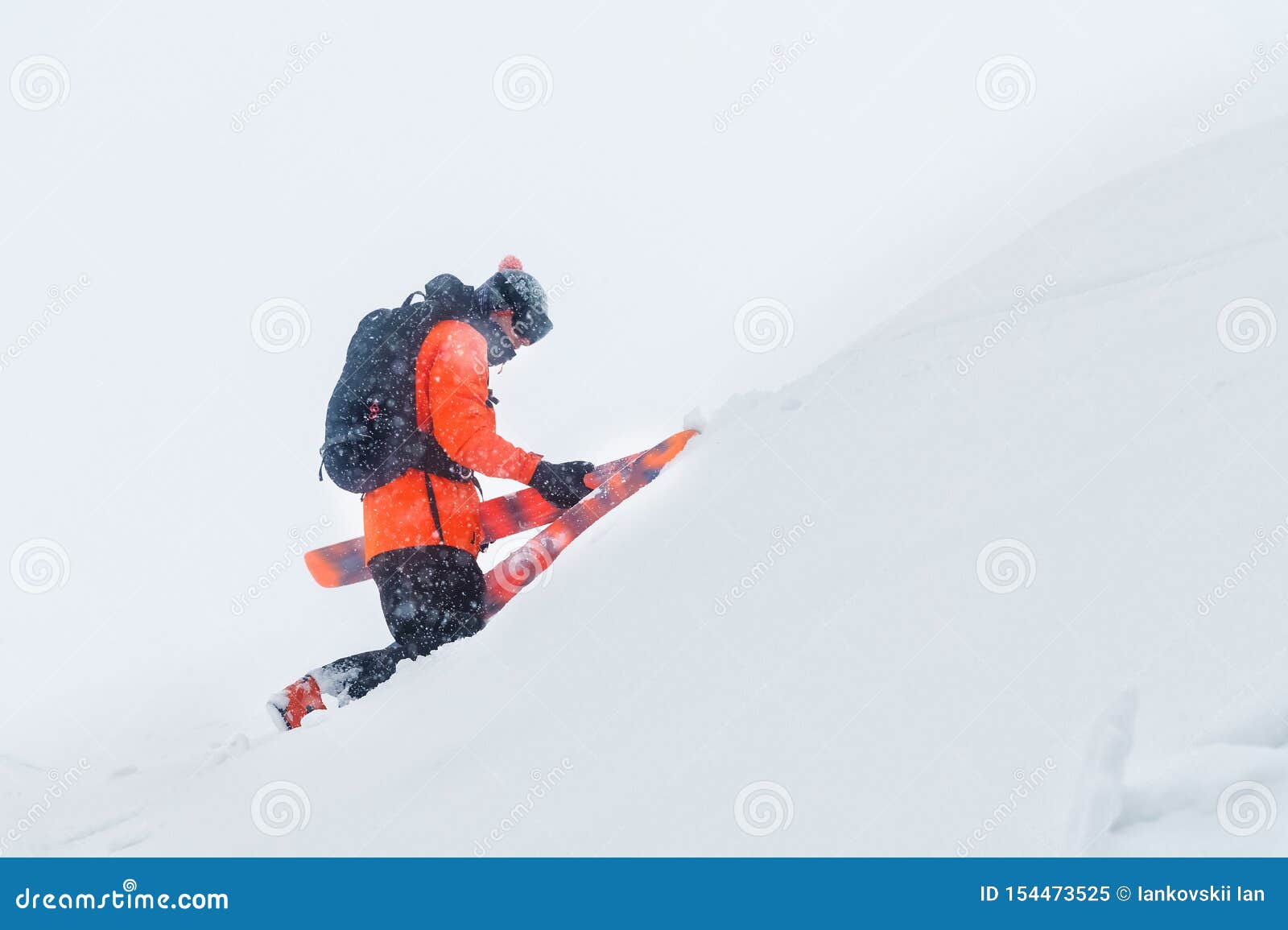 Portrait of a Professional Skier Climbing a Slope with Skies in a ...