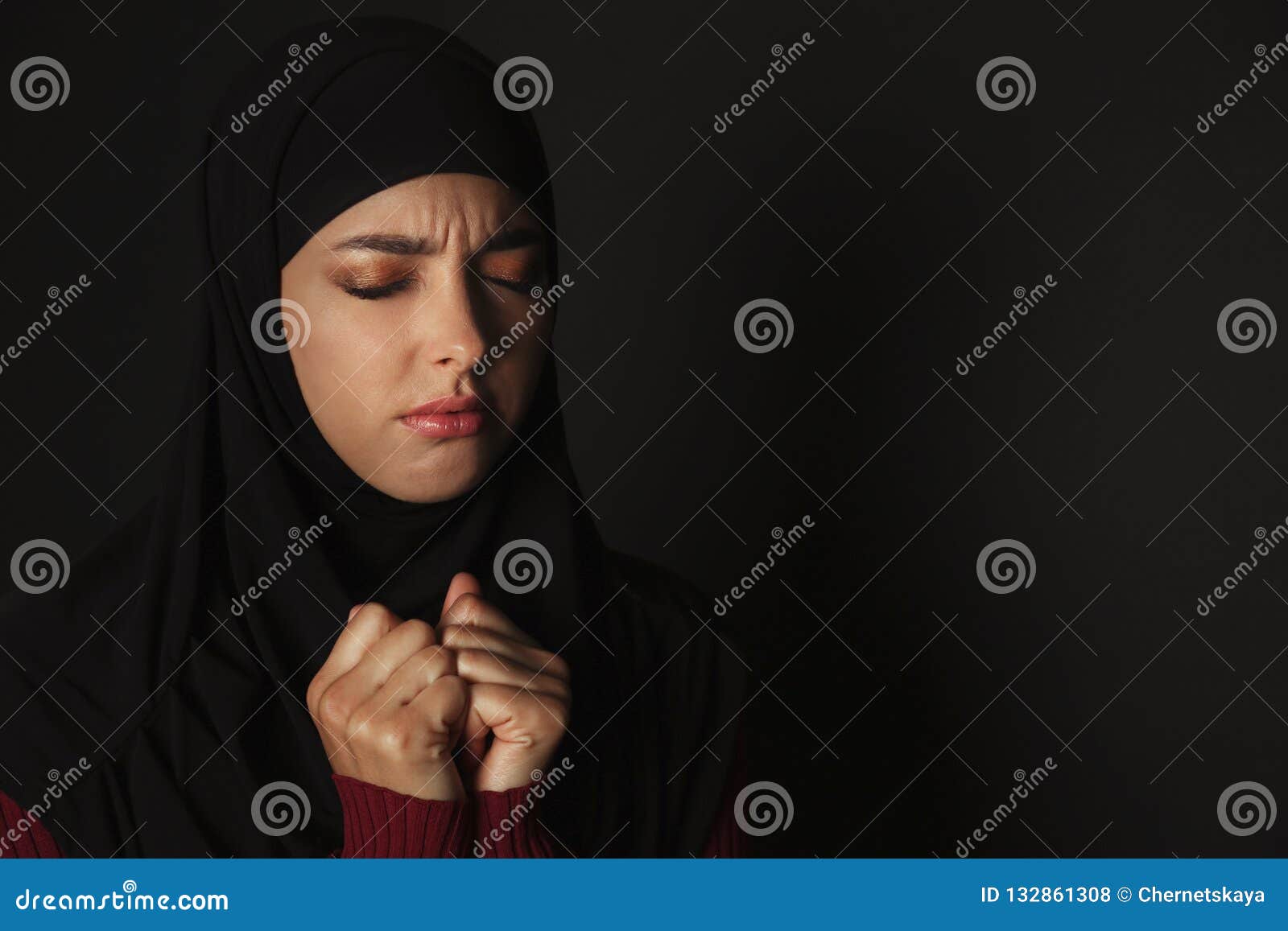 Portrait of Sad Muslim Woman in Hijab Praying on Dark Background. Stock ...