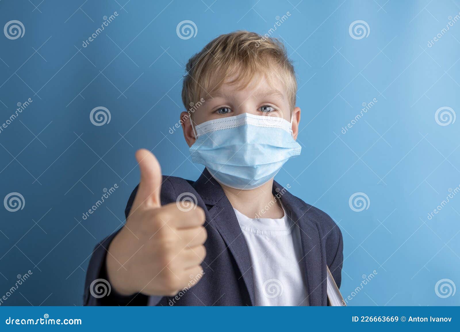 Portrait of School Boy with Face Mask and School Uniform. Blue