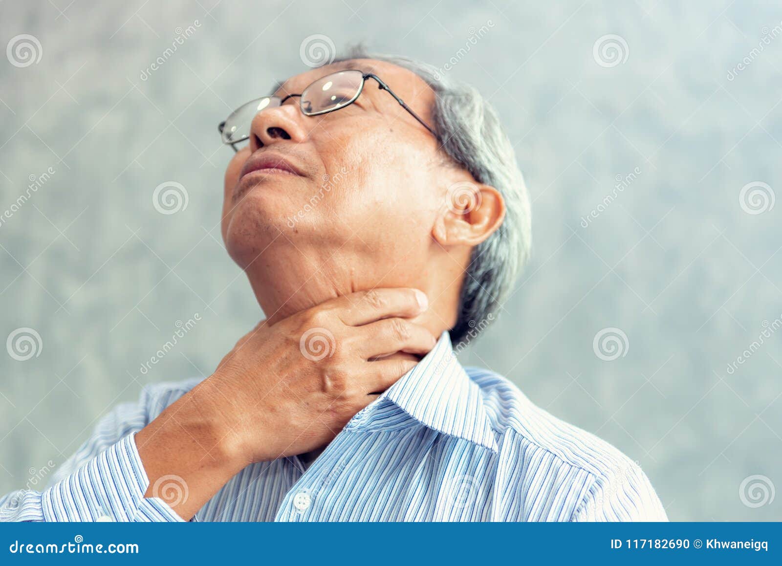 portrait of senior man touching his neck and having throat irritation