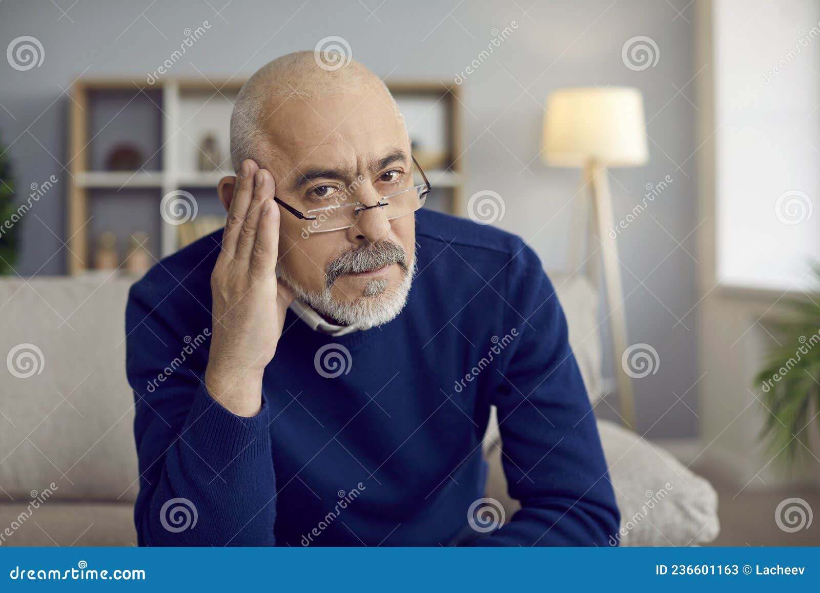 portrait of serious senior man in glasses feeling skeptical and doubtful about your idea