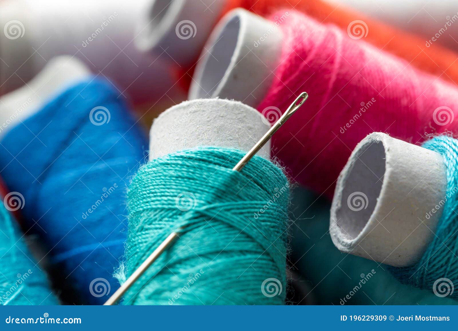 A Needle Stuck In A Spool Of Thread Stock Photo - Download Image