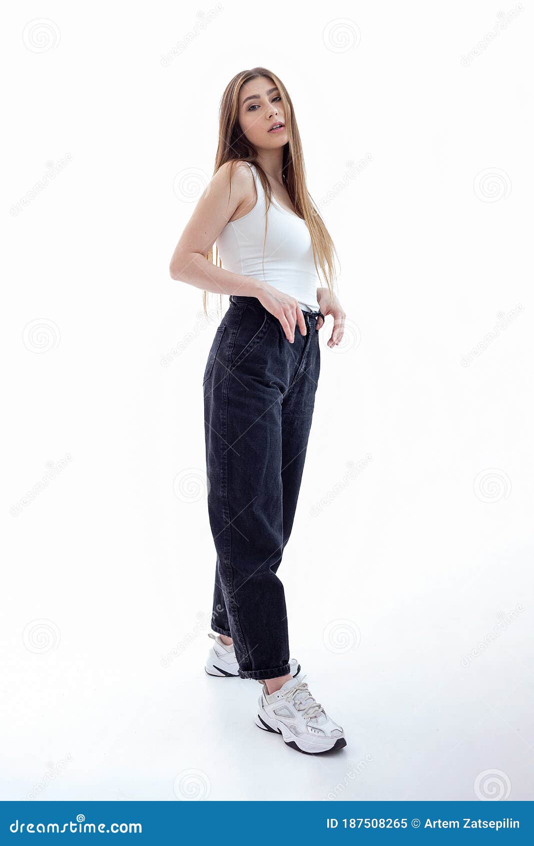 A Young Teenage Girl In A White Shirt And Black Jeans On A Black Studio  Background Stock Photo - Download Image Now - iStock